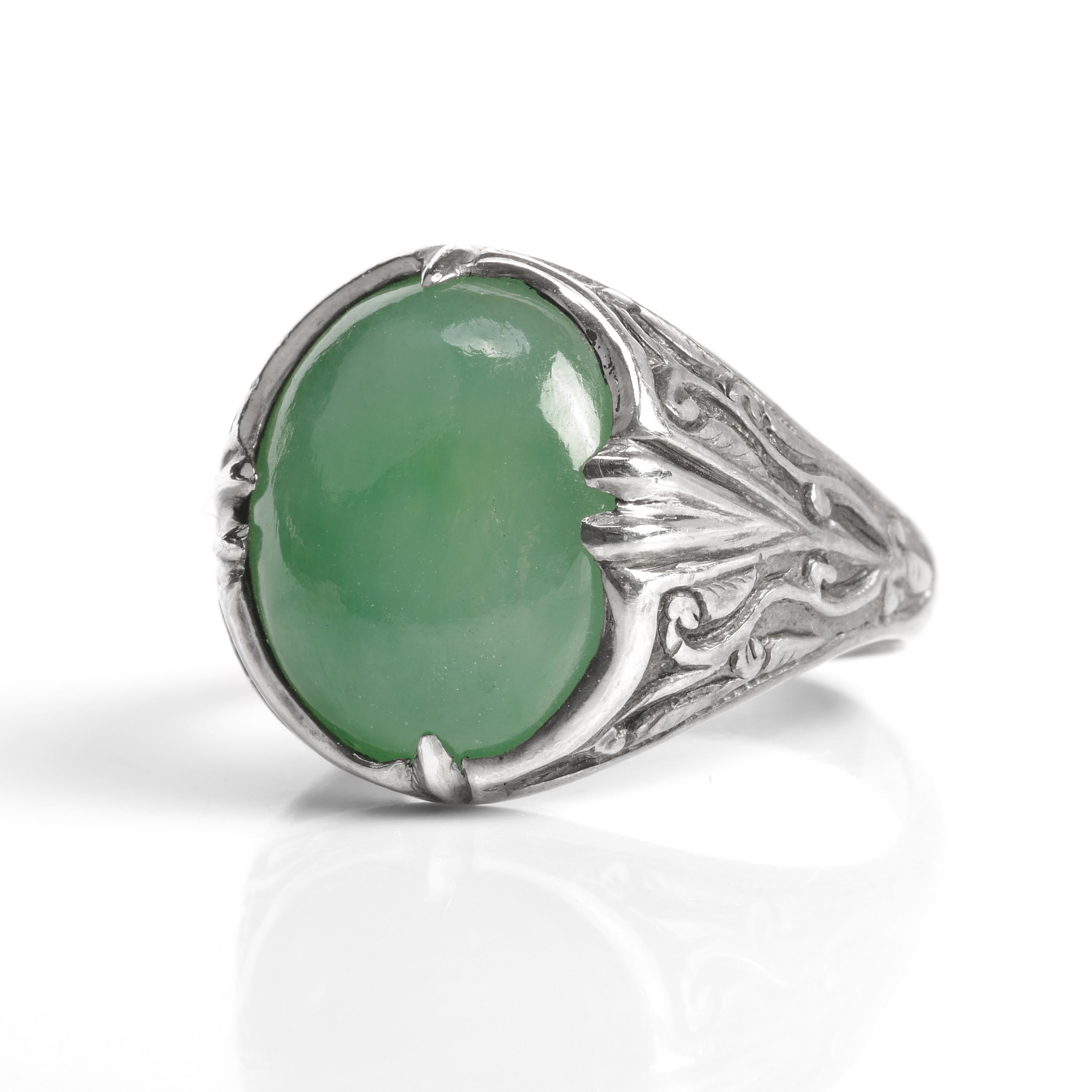 Simple but powerfully beautiful, this Art Nouveau-era ring (circa 1910) was entirely hand-fabricated in silver and features a very fine medium-green cabochon of natural and untreated jadeite jade from Burma. The jade gem has an even tone and high