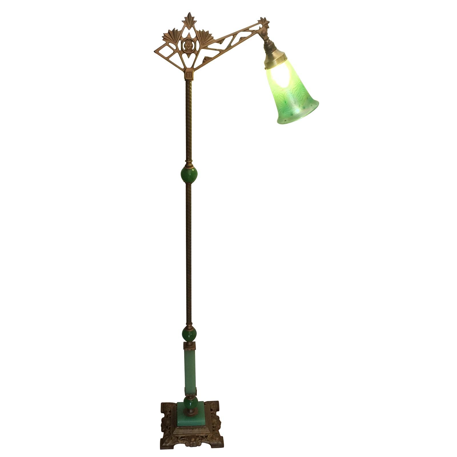 Art Nouveau American bridge lamp, with solid, lime green glass in slightly variable shades of green. The uppermost shade is in a green “Pulled Feather” shade in fantastic detail; the upper shade and holder can be tilted to adjust the light