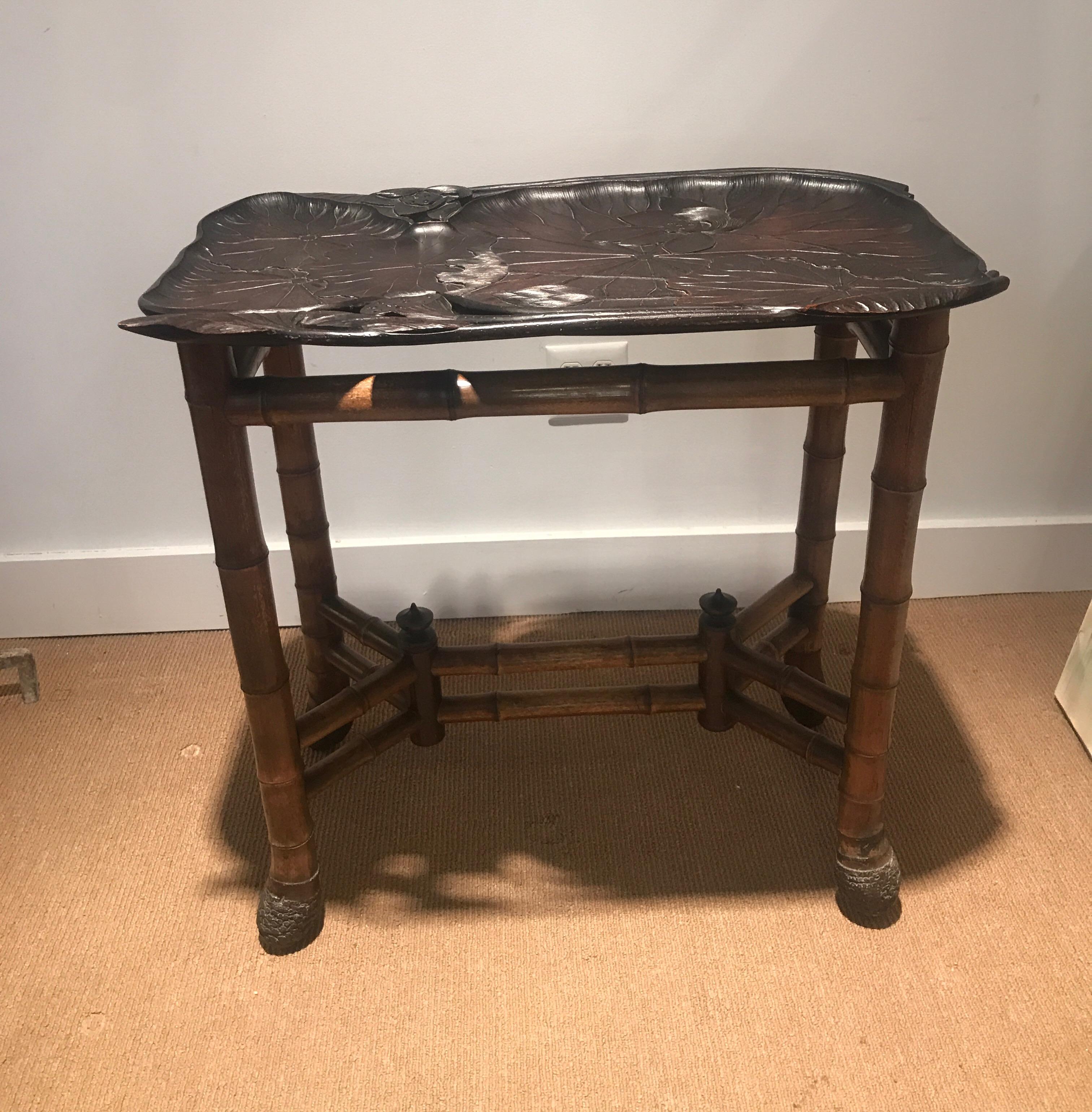 A beautifully carved antique Japanese tray signed by the artist with a natural custom bamboo base. This beautiful tray was made for the European market and in well cared for original condition. The hand carved top with lotus design and stained to