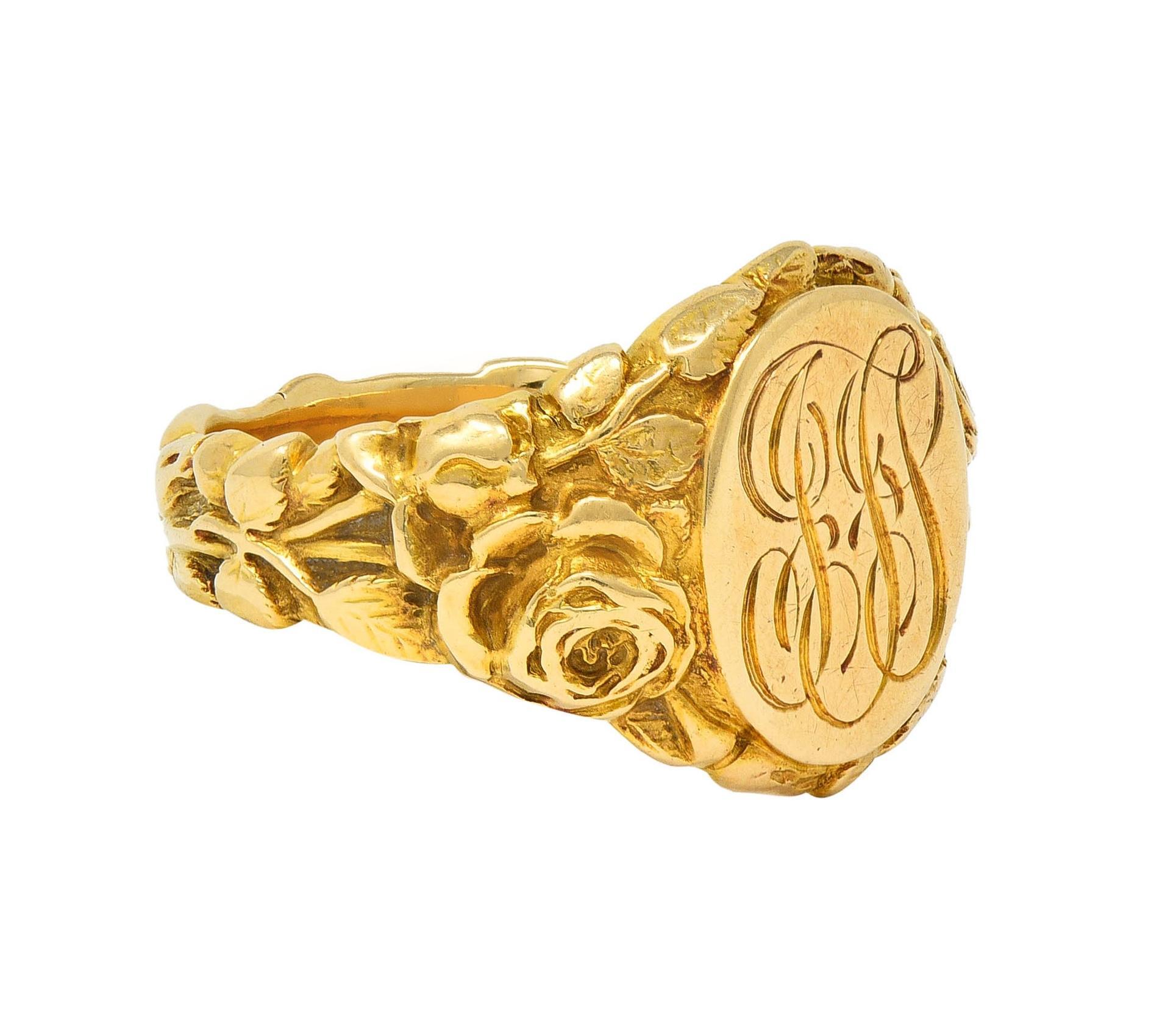 Centering an oval-shaped signet face centering an engraved monogram of the initials 'JFS'
With a bombé shaped surround highly rendered with grooved roses
Depicting blooms, buds, stems, and foliates fully around
Inscribed 'June 25 '03'
Stamped for 14