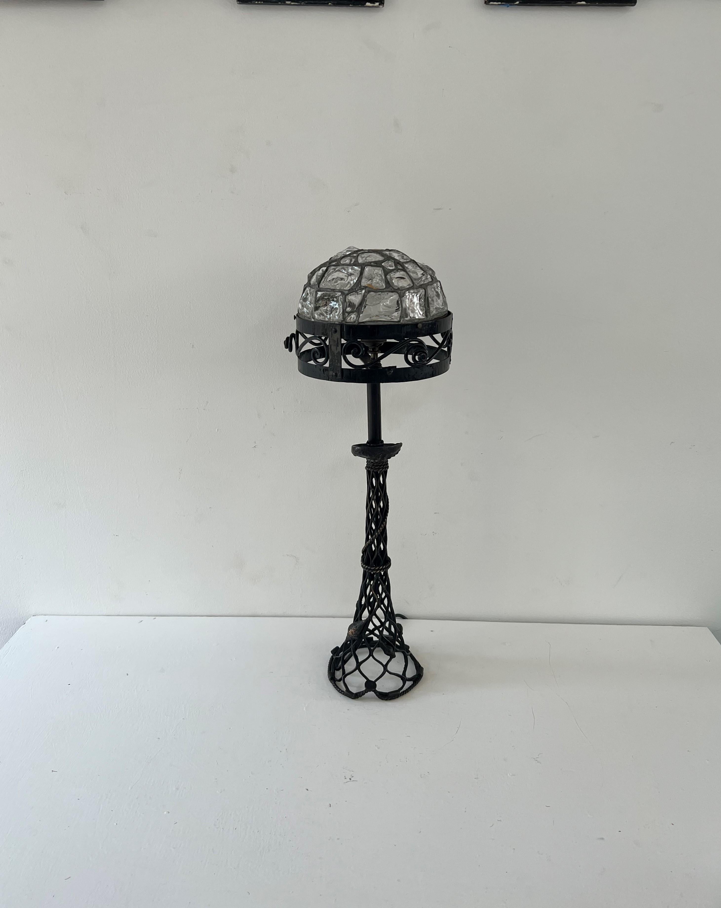 Jugendstil or Art Nouveau table lamp, most likely Austrian circa 1910.
The base has been cast or forged with sealife, the metal is most likely bronze as it shines golden in some places where the patination has rubbed off.