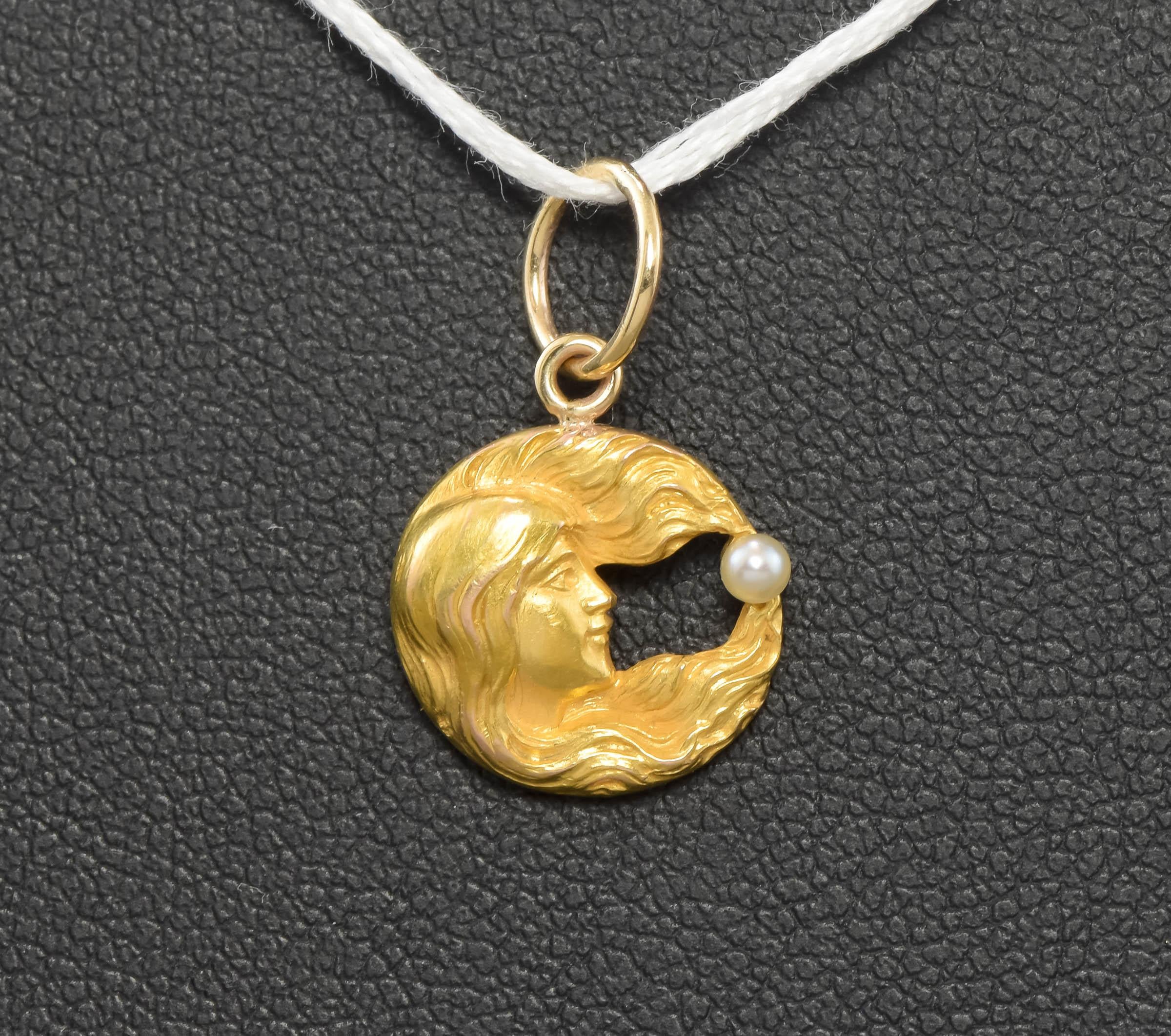 A wonderful true Art Nouveau period Celestial piece - this charm pendant was converted from a fine pin dating to approximately 1910 and is now a sweet charm pendant ready to add to your favorite chain.

Finely crafted of 14K solid gold with a rich,