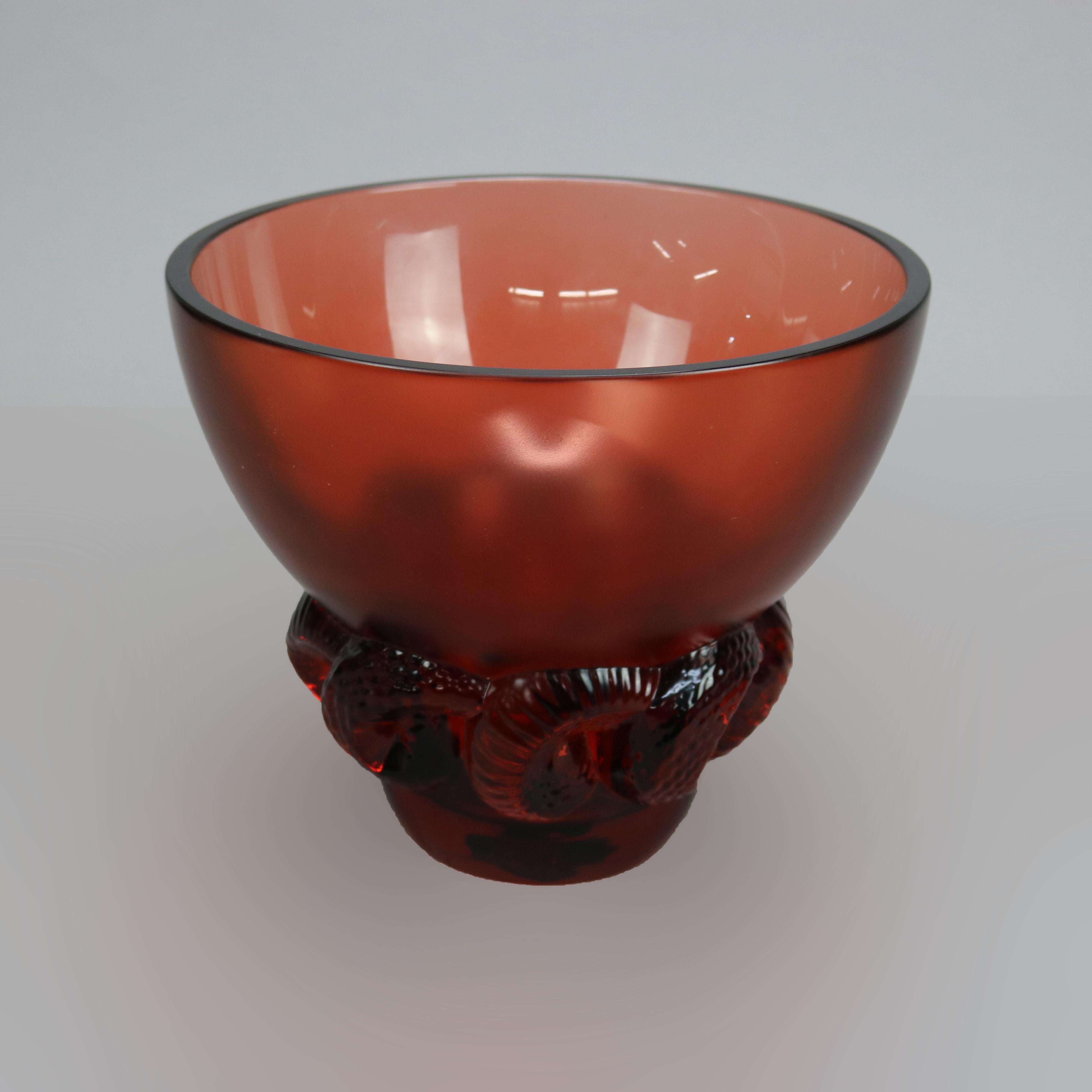 A French Art Nouveau center bowl by Lalique offers art glass construction with base having stylized rams horn elements, signed on base as photographed, 20th century

Measures - 8.25''H x 9.75''W x 9.75''D.