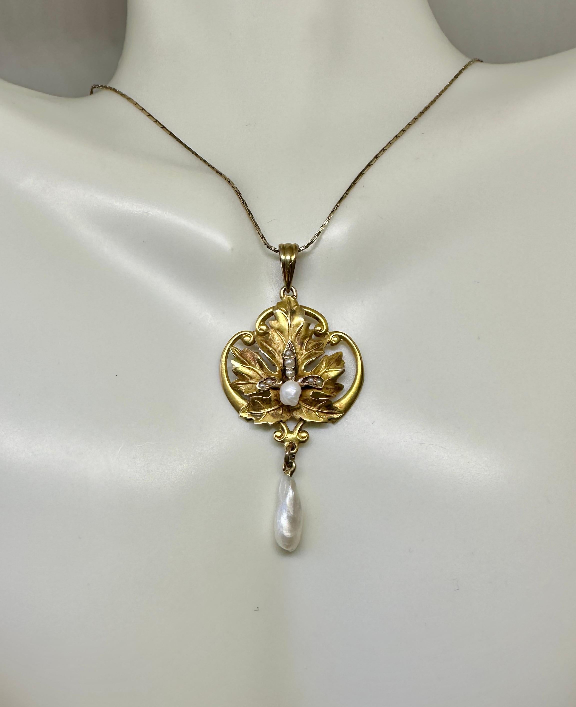 THIS IS A GORGEOUS VICTORIAN - ART NOUVEAU PENDANT IN THE FORM OF A BEAUTIFUL LEAF MOTIF DESIGN ADORNED WITH ELEGANT NATURAL PEARLS.  THE FULLY MODELED LEAF IS SET IN A CURVING OPEN WORK SURROUND IN 10 KARAT GOLD.  IN THE CENTER OF THE LEAF IS A