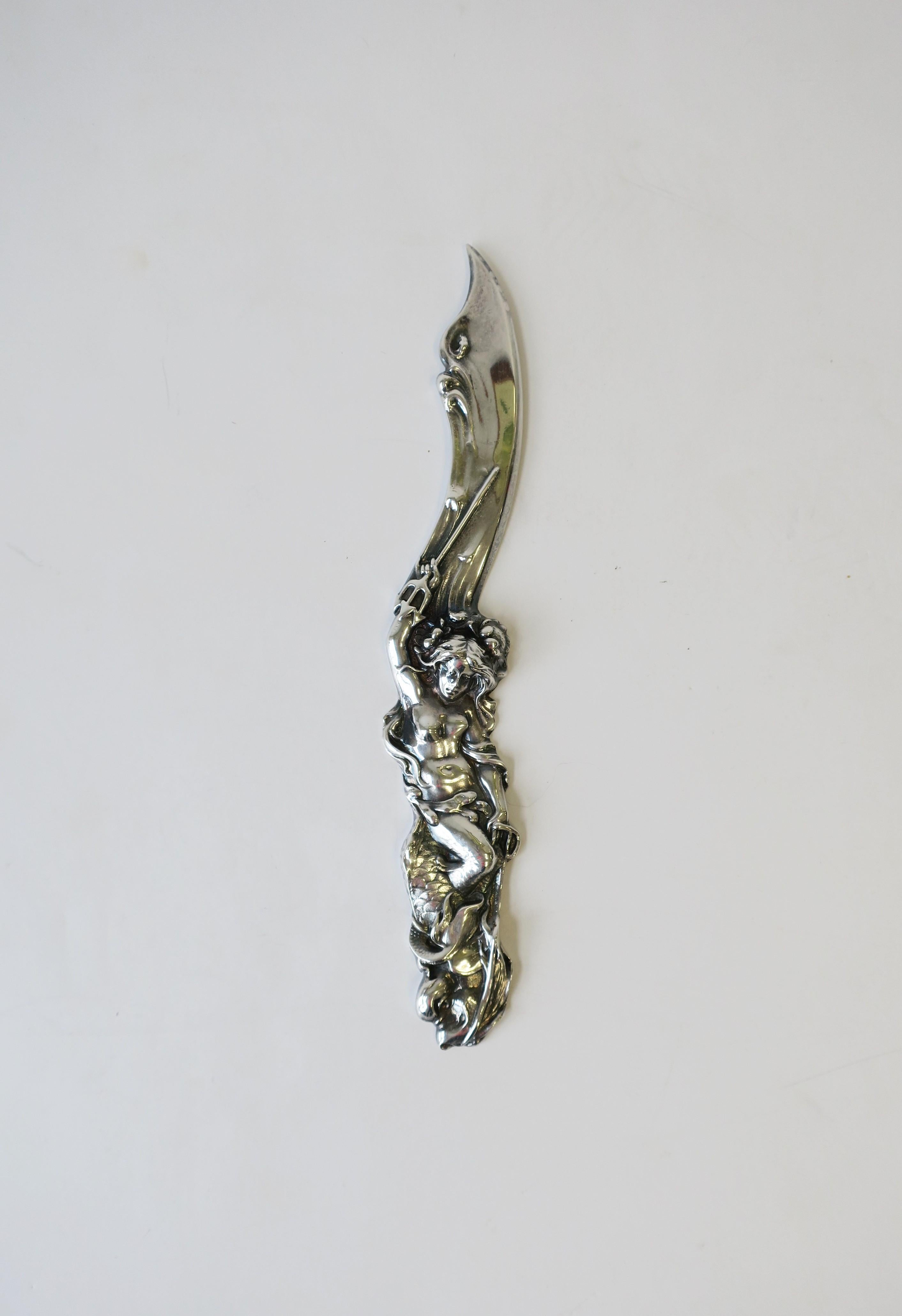 A very beautiful knife form Art Nouveau style letter opener with female mermaid repousse, circa 1990s.
Marked and dated on back: MMA 1991. Piece measures: 1.5