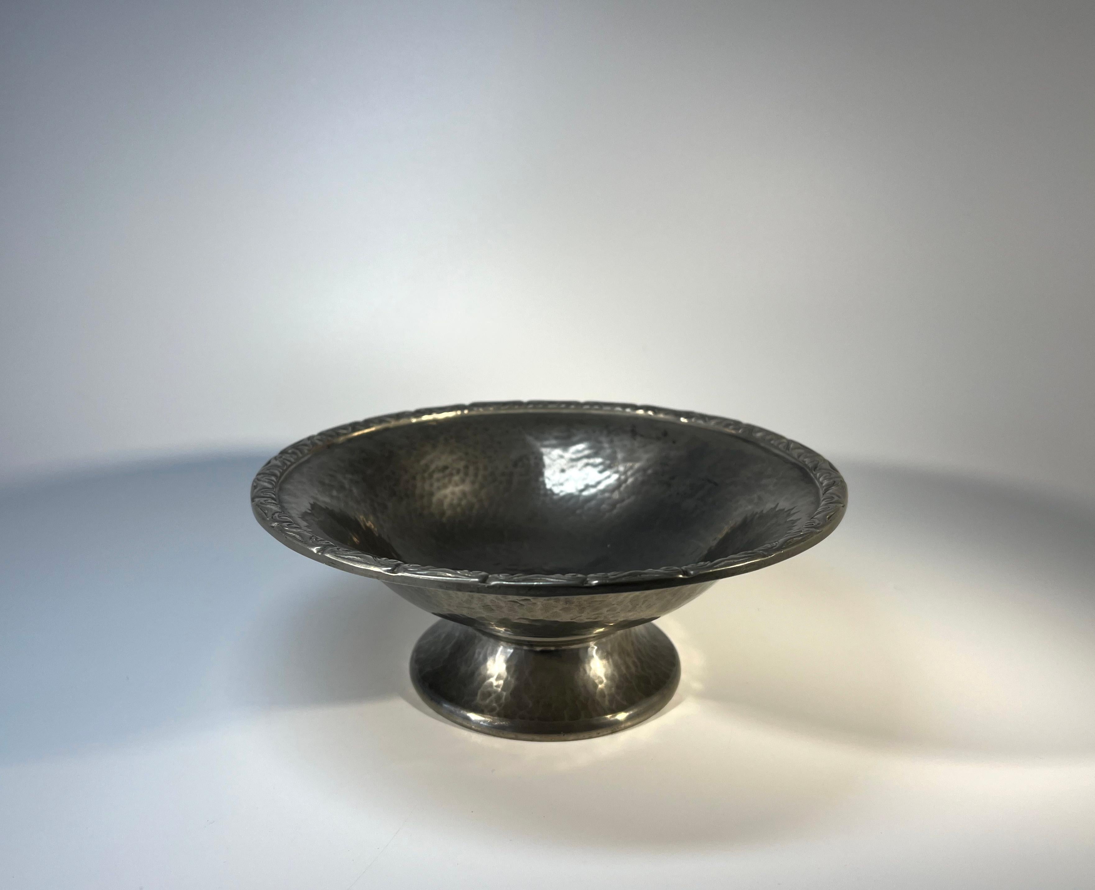 Art Nouveau antique pewter footed dish for Liberty & Co., Regent Street, London
Superb dark pewter patina and hand hammered with stylised edging decoration
Circa 1910
Signed English Pewter, Liberty & Co 01354 to base
Height 2.5 inch, Diameter 6.75