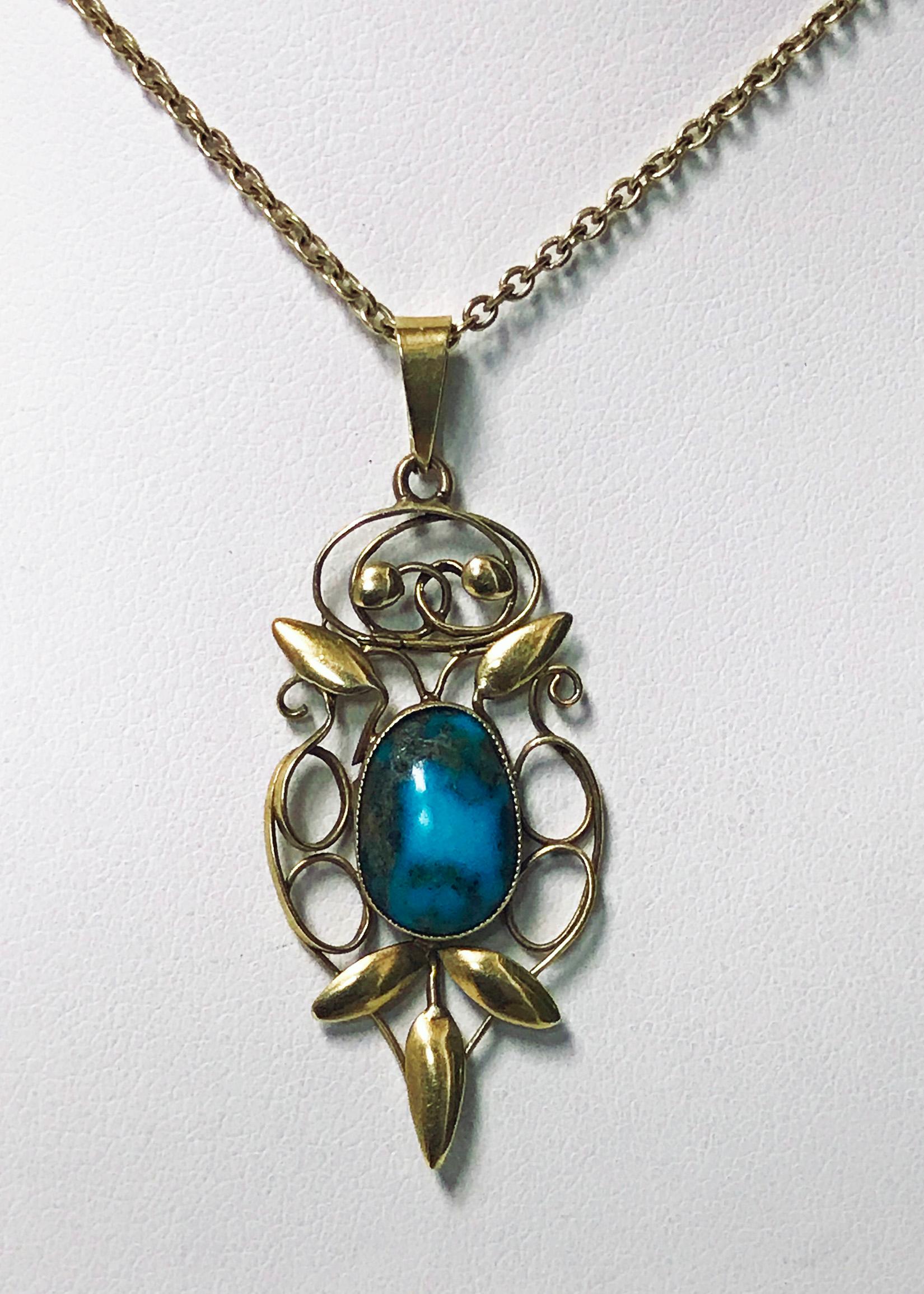 Rare liberty gold turquoise Arts & Crafts Art Nouveau pendant, William Haseler, circa 1900. Fully signed for W. H Haseler and 15-carat for Liberty, oval cabochon turquoise bezel set drop with polished foliate gold surround, together with 9-carat