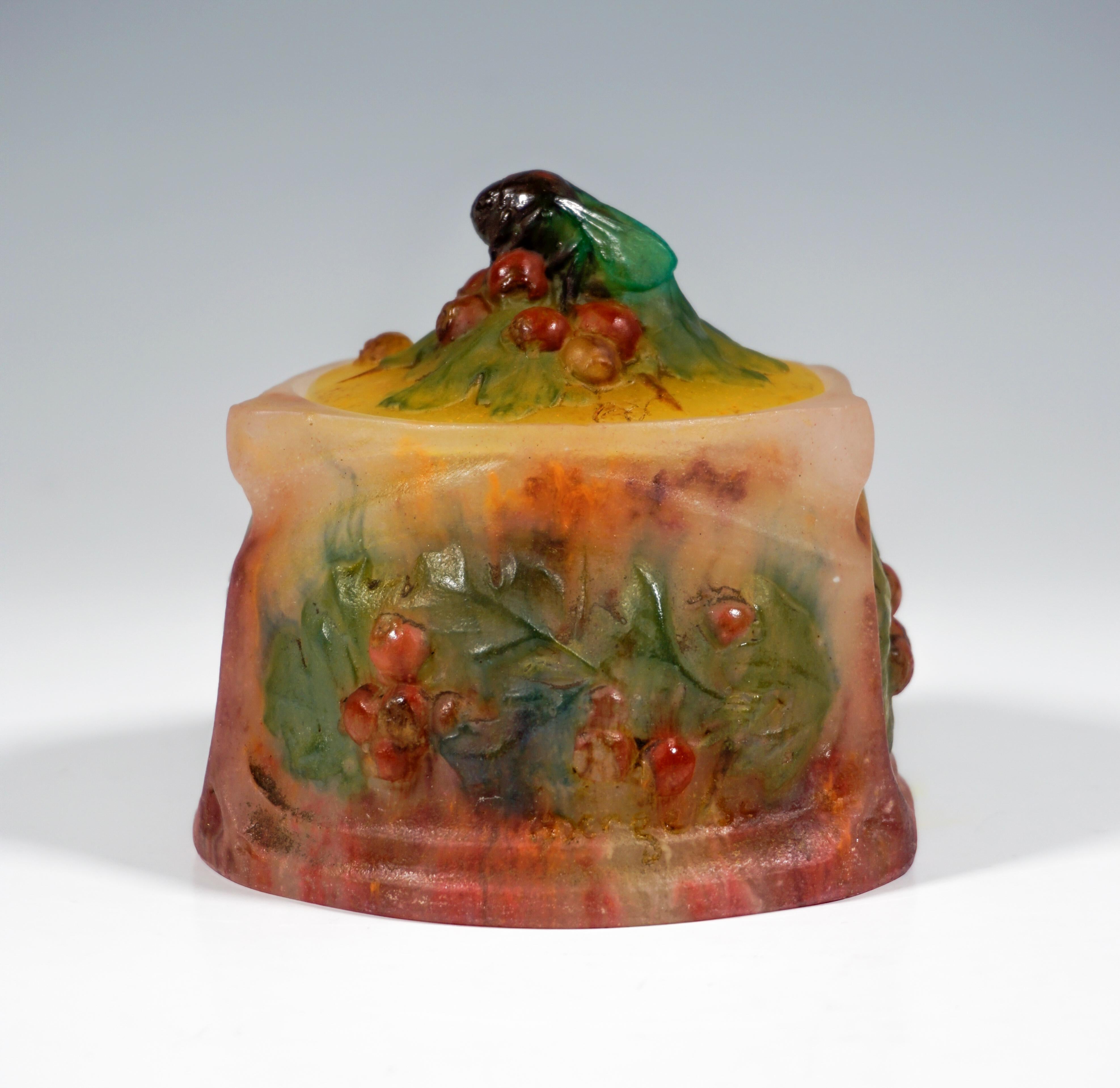 Round lidded box, bowl divided by pilaster and frames into three panels filled with leaves and flowers in relief, flat, round lid with a bumblebee enthroned on leaves and berries as a knob. Signed 'AWALTER NANCY' and 'hBergé SC' on the walls and