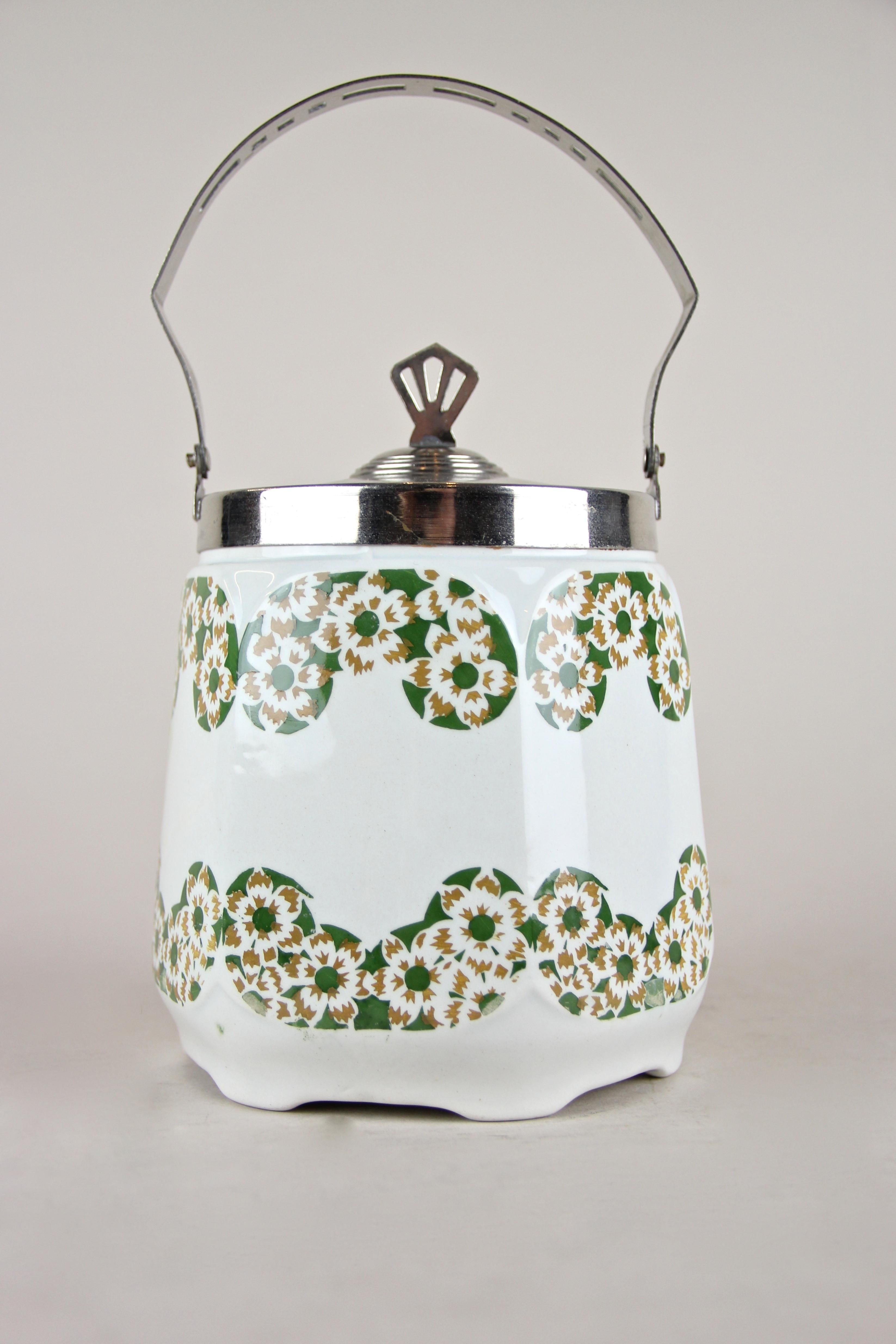 Lovely Art Nouveau lidded ceramic jar from Austria, circa 1915. This piece from the early 20th century shows a beautiful cherry blossom design in green and light brown. A nice chromed mounting with perforated handle and a great designed lid makes