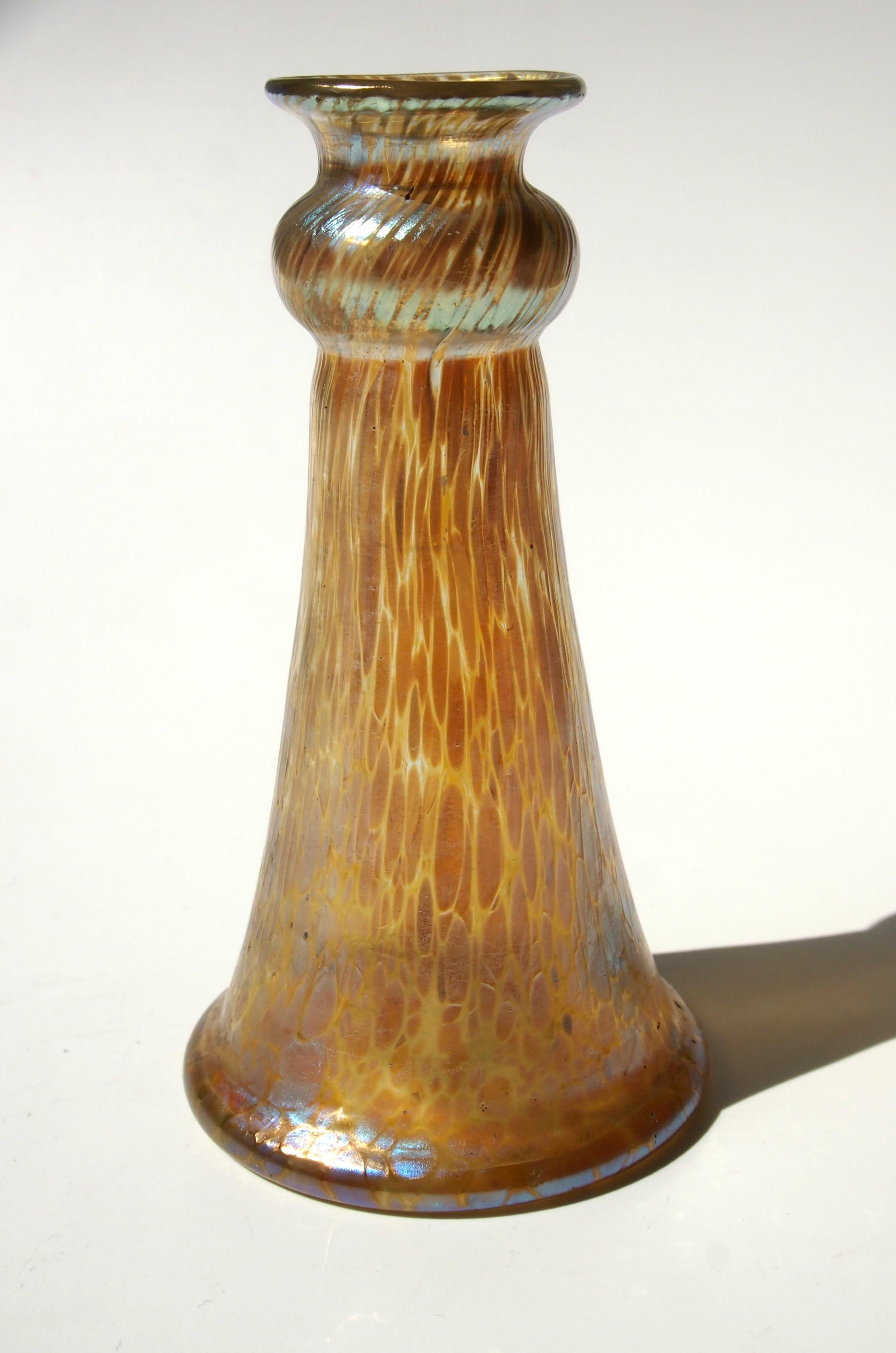 A small Art Nouveau Loetz 'Candia' (gold on clear) Papillon (Butterfly wing) vase. This iridised finish was first created in 1898 and this is an early example. 

Loetz was and still is probably the most famous and most collected of the great