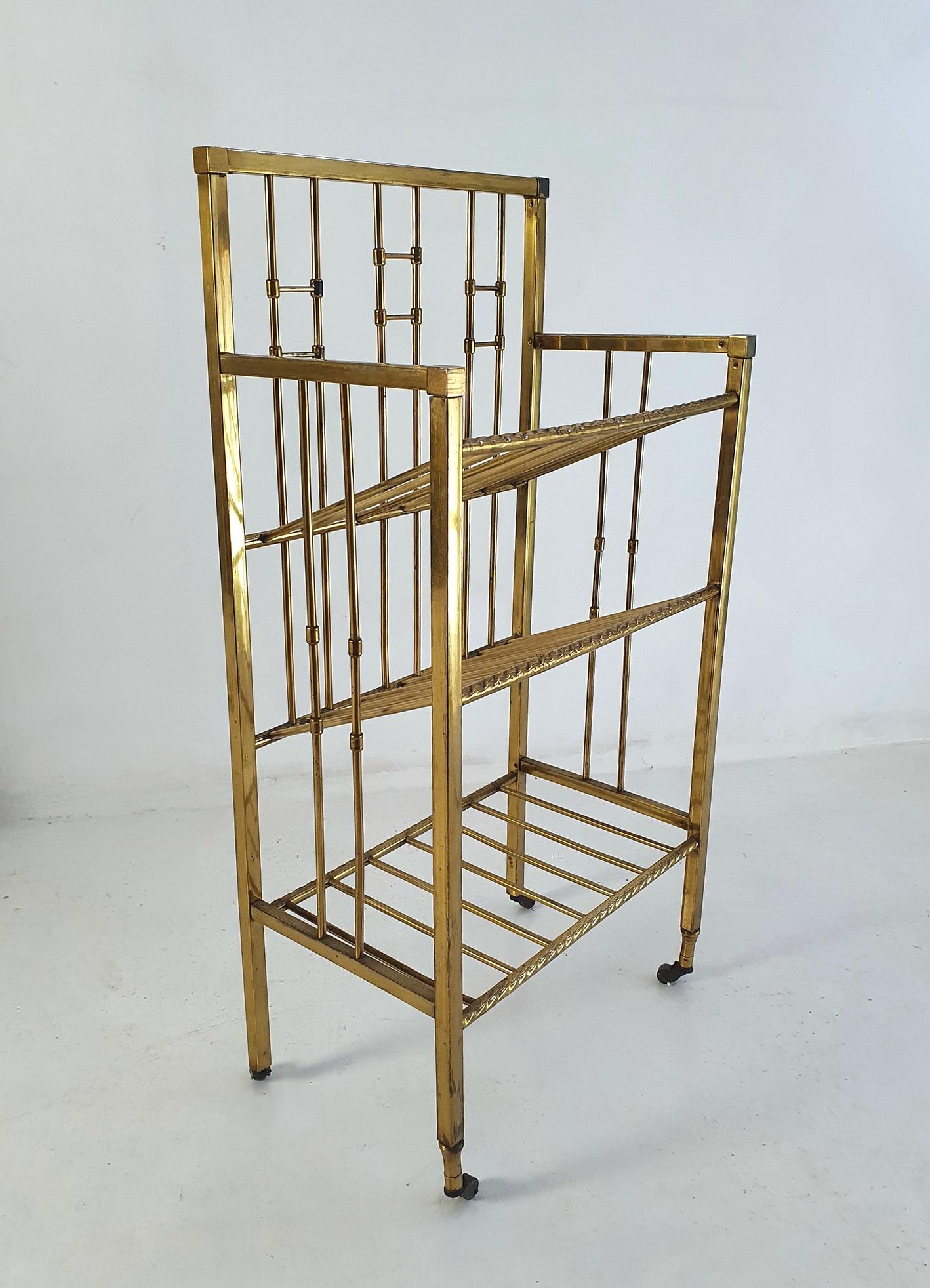 A tall and elegant rack for magazines or musical notes in brass hand made in Italy during the early 1900's. It would stand as well by the sofa as by the grand piano. As the shelves are slanted it can hold large magazines even though it is only 30 cm