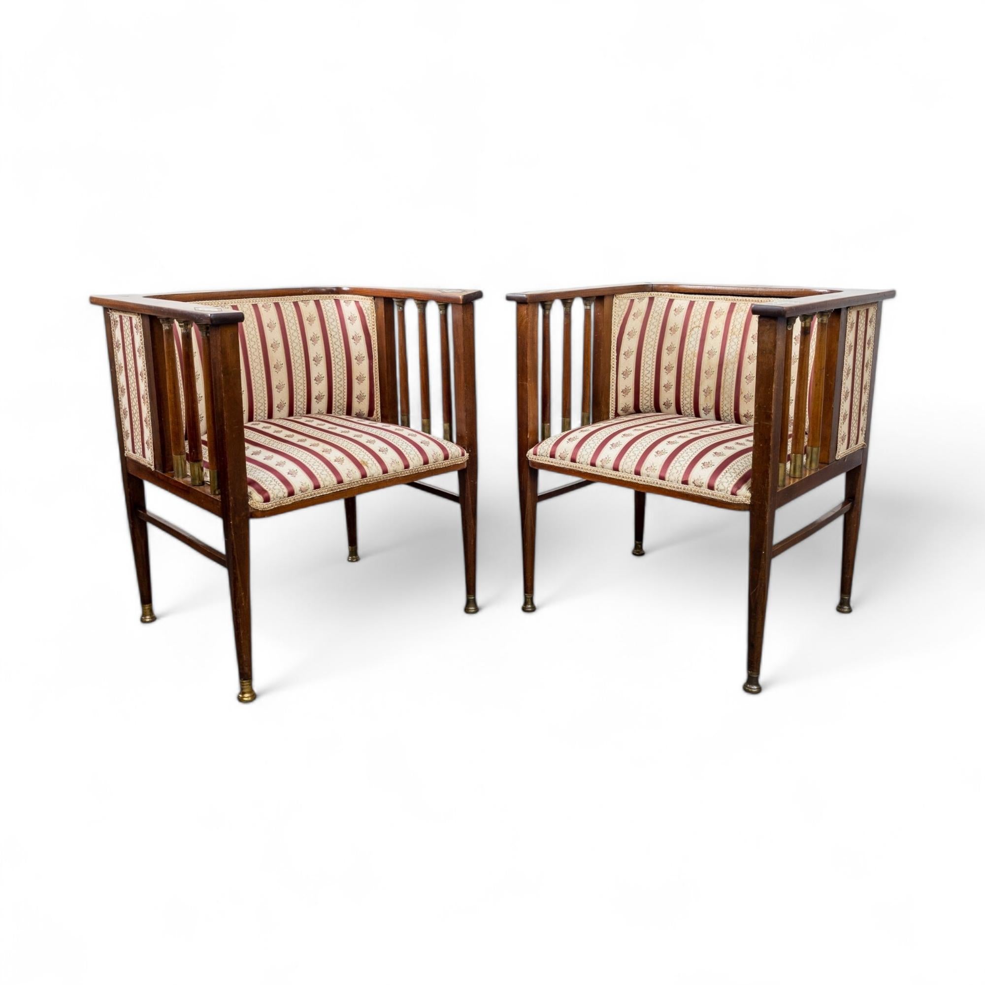 Very rare drawing room armchairs designed by German artist Hans Christiansen (1866-1945) around the 1910s. Likely manufactured by Ludwig Schäfer, Mainz. Made of solid mahogany and mahogany veneer with metal inlays and brass fittings. In very good