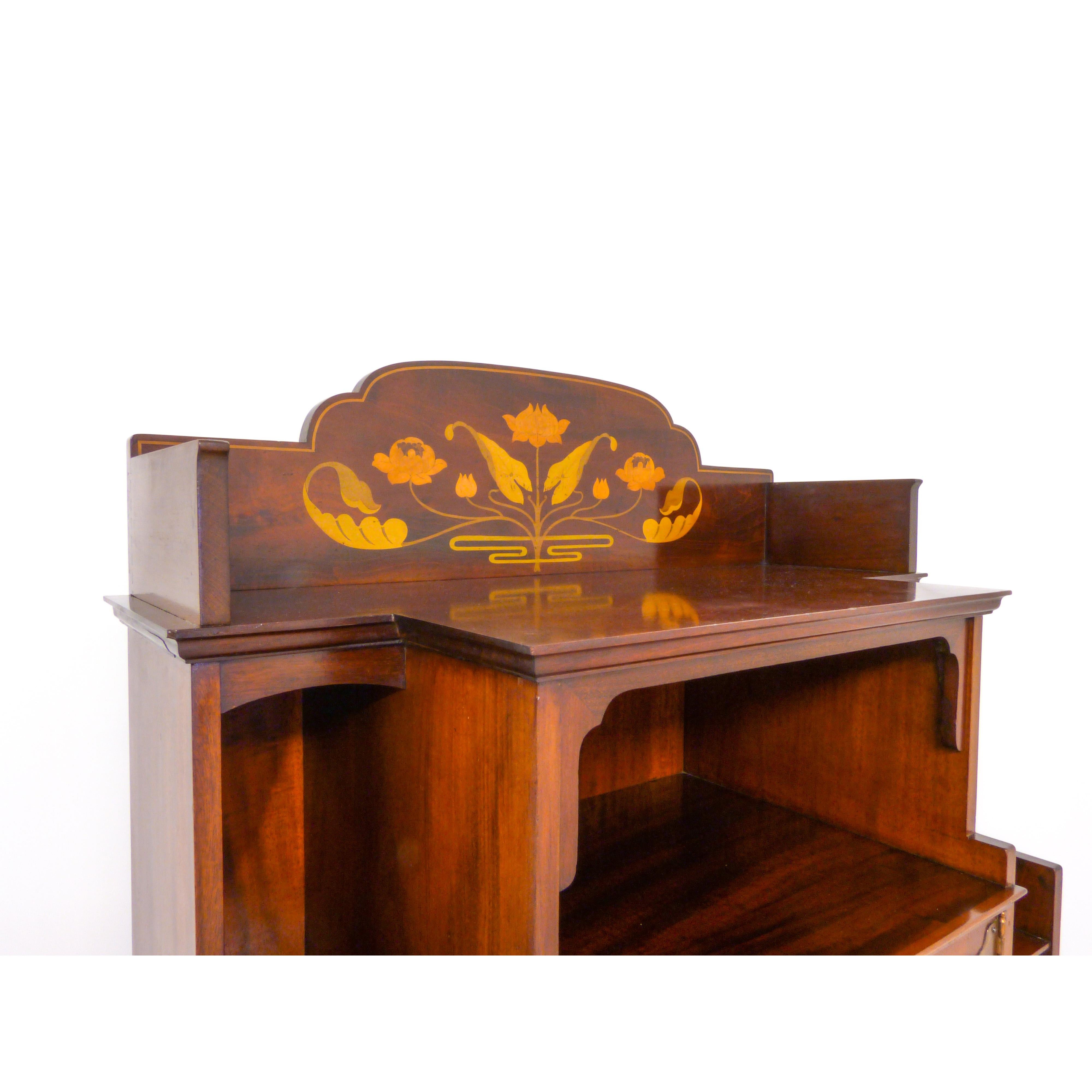 A stunning Art Nouveau antique music cabinet (circa 1890) of exceptional quality and extreme rarity. The body of the piece is solid mahogany throughout including the back and has beautiful satinwood with ebony cross banding along with boxwood