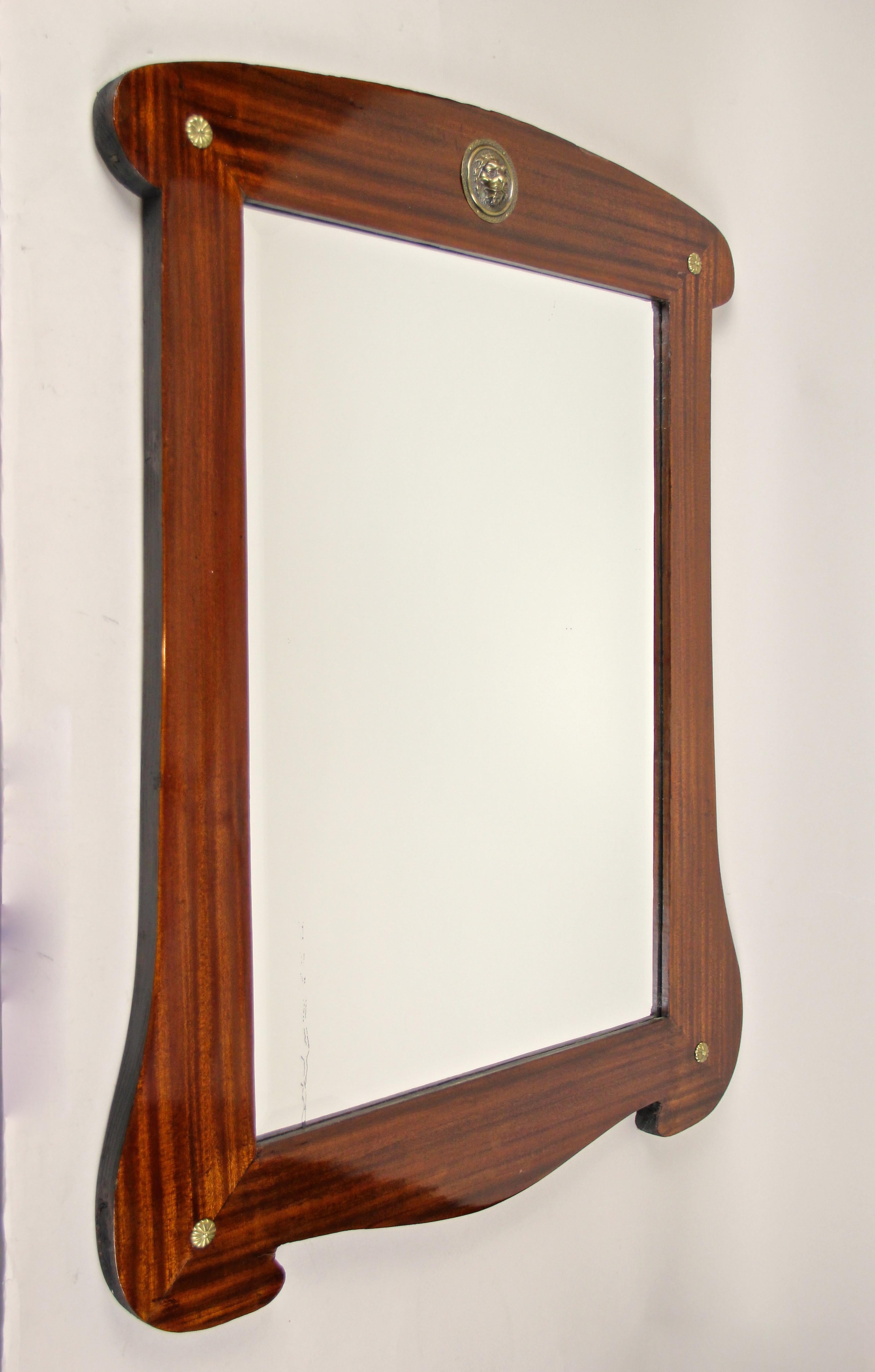Beautiful mahogany wall mirror from the famous Art Nouveau period in Austria, circa 1900. The newly restored mahogany frame impresses with an artistic combination of rounded edges, curved lines and smooth edges, that all work together beautifully