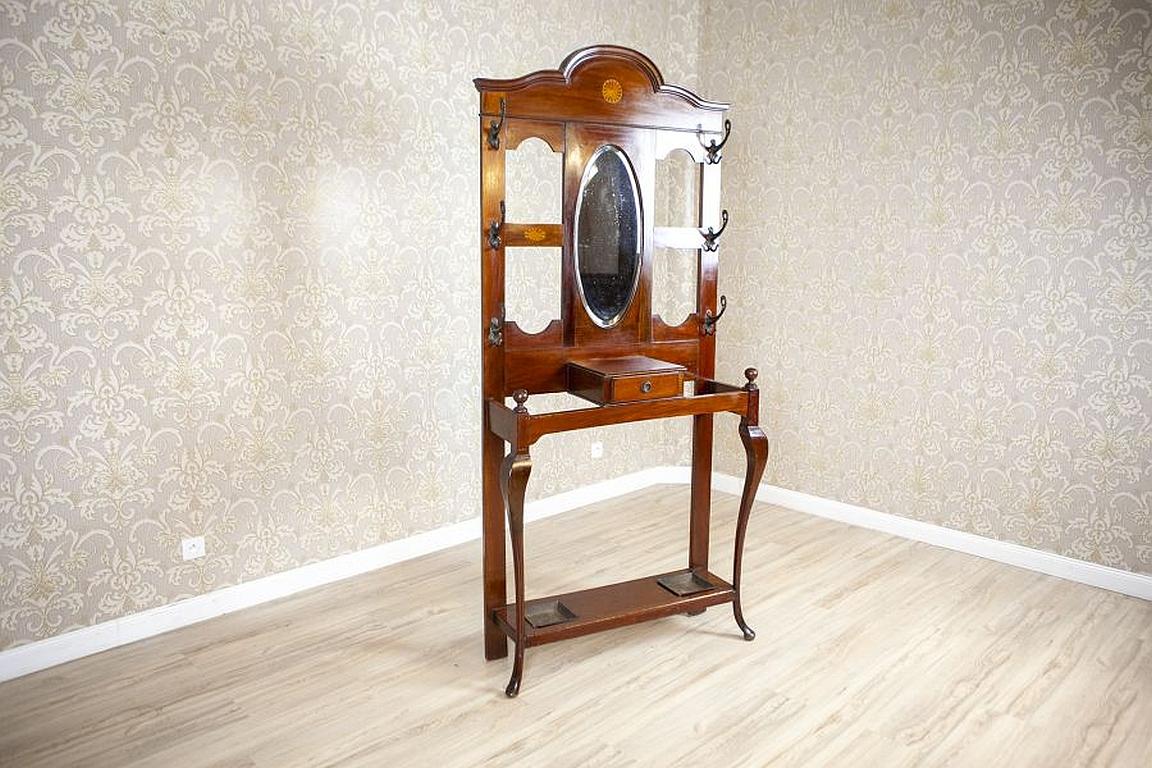 Art Nouveau Mahogany Wardrobe in Brown with Mirror, circa 1912

We present you this openwork mahogany wardrobe circa 1912. There is a drawer for brushes under the filleted mirror in the central section. Moreover, there are three rows of brass hooks