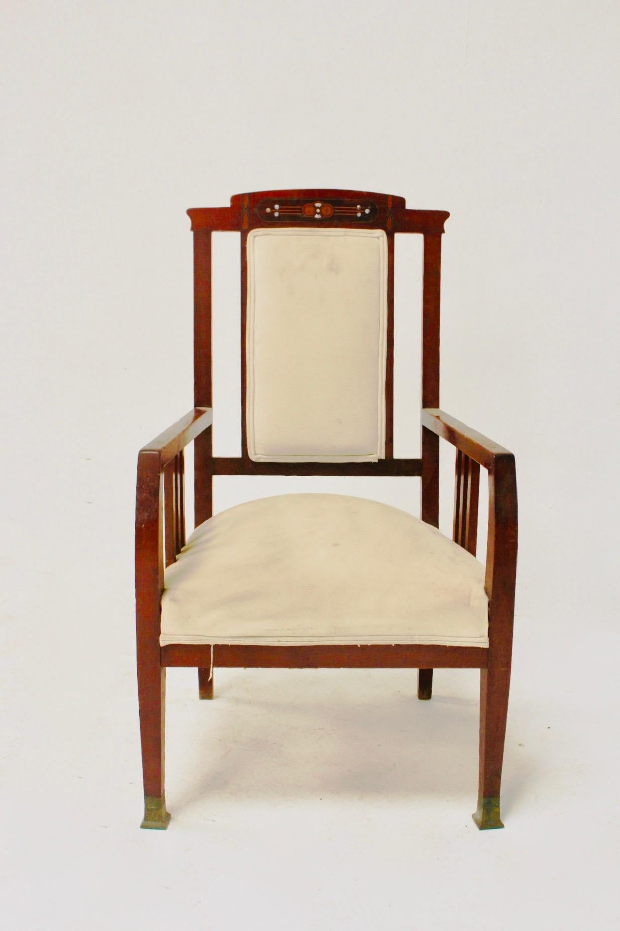 Art Nouveau or Spanish modernist mahogany wood armchair, Spain, late 19th century.
Wood and structure are in very good condition.
- With inlay mother of pearl
- Brass accents at the feet with old Patina.

Fabric in distressed condition.
 