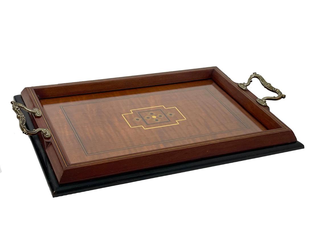 An Art Nouveau mahogany wooden tray. 

Mahogany wooden tray handcrafted in the time of Art Nouveau (1890-1910). With embedded wood and floral Art Nouveau handles. Rectangular tray with raised edge and with glass plate.

The measurements are 3,5