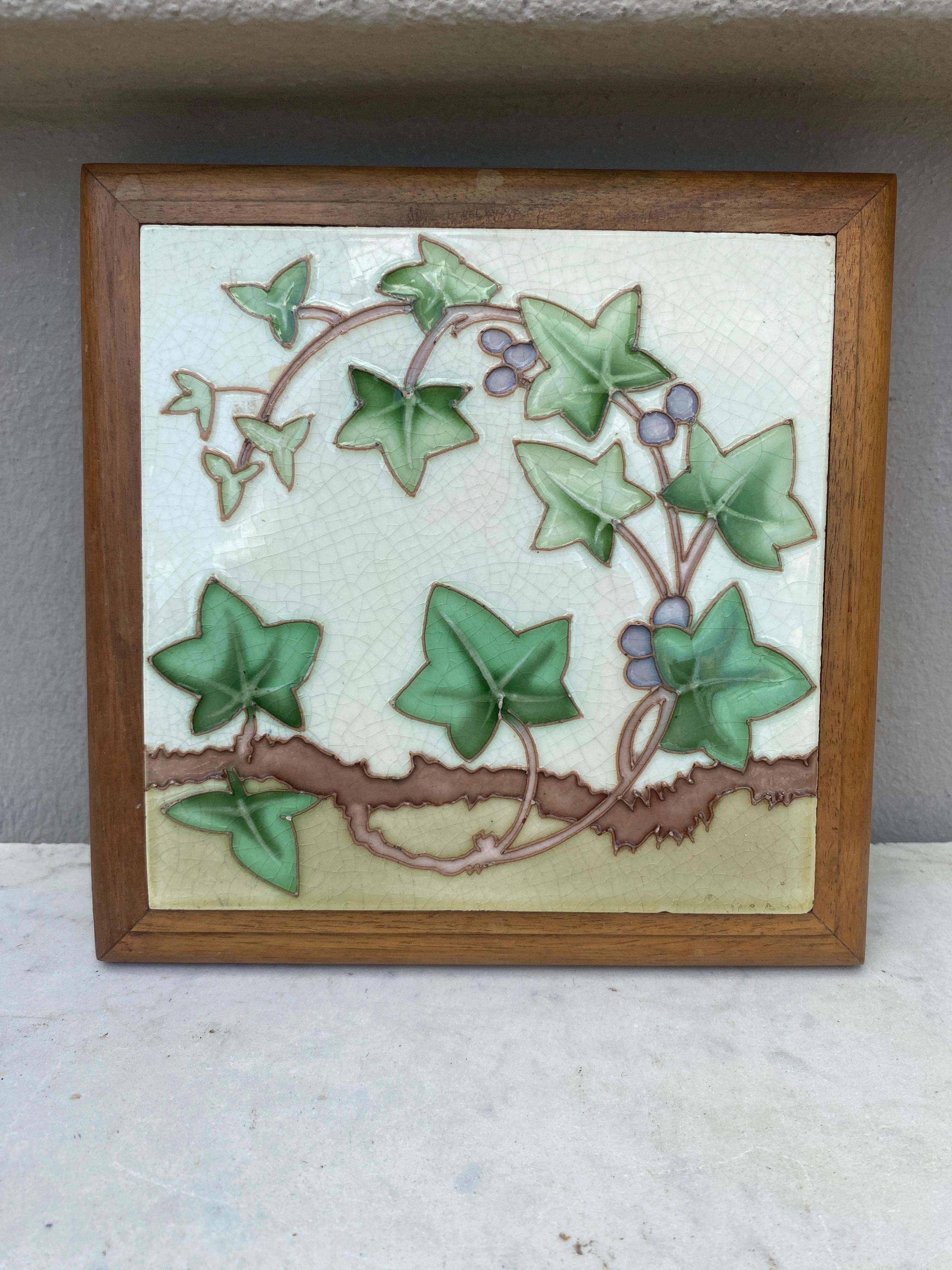 Art Nouveau Majolica trivet in a footed wood frame, circa 1900.
ivy pattern.
7.5