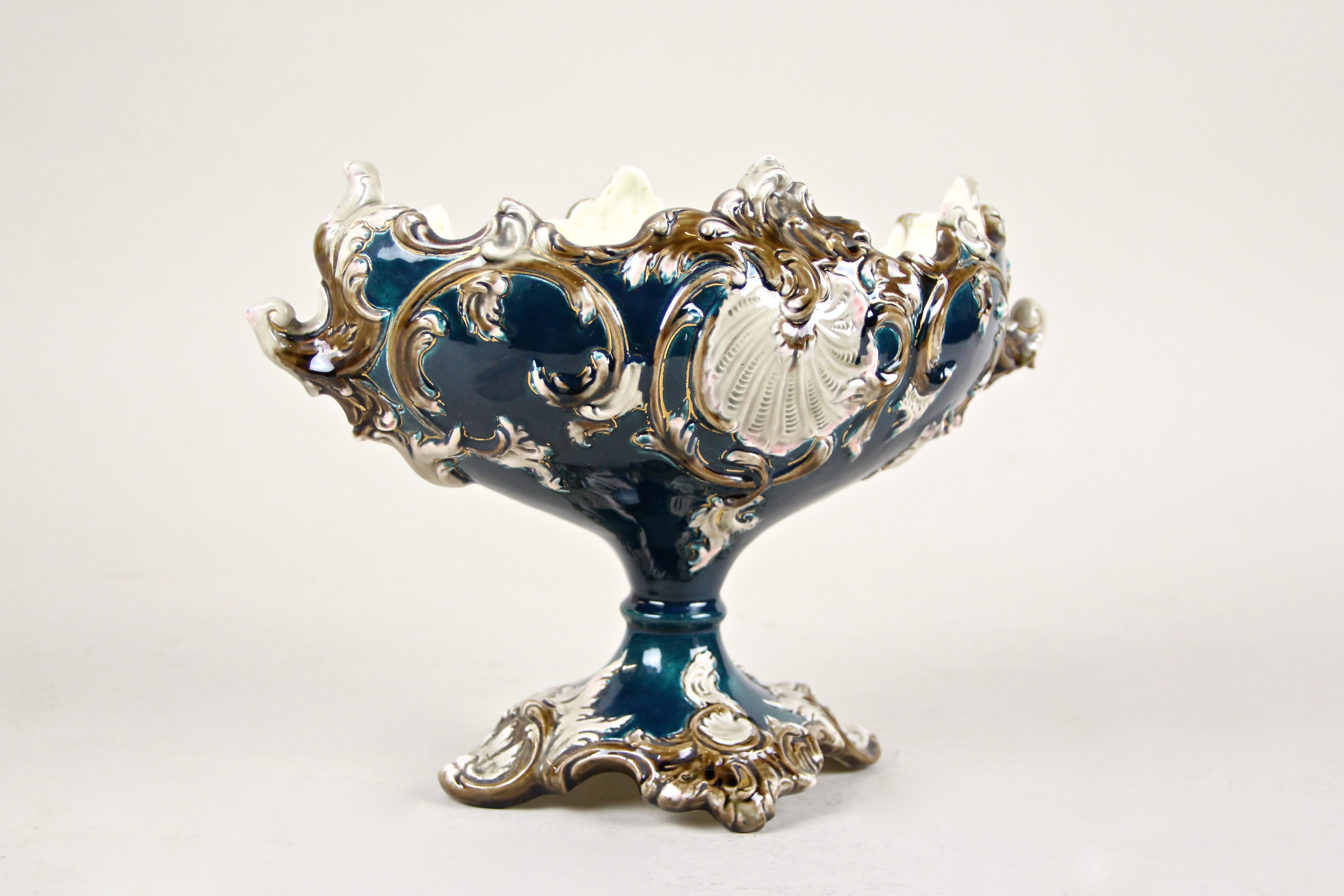 Delicate Art Nouveau Majolica jardinière from the renown manufactory of Julius Dressler from circa 1905 in Bohemia. This gorgeous shaped jardinière impresses with its floral design, combined with a beautiful coloration in petrol and different brown