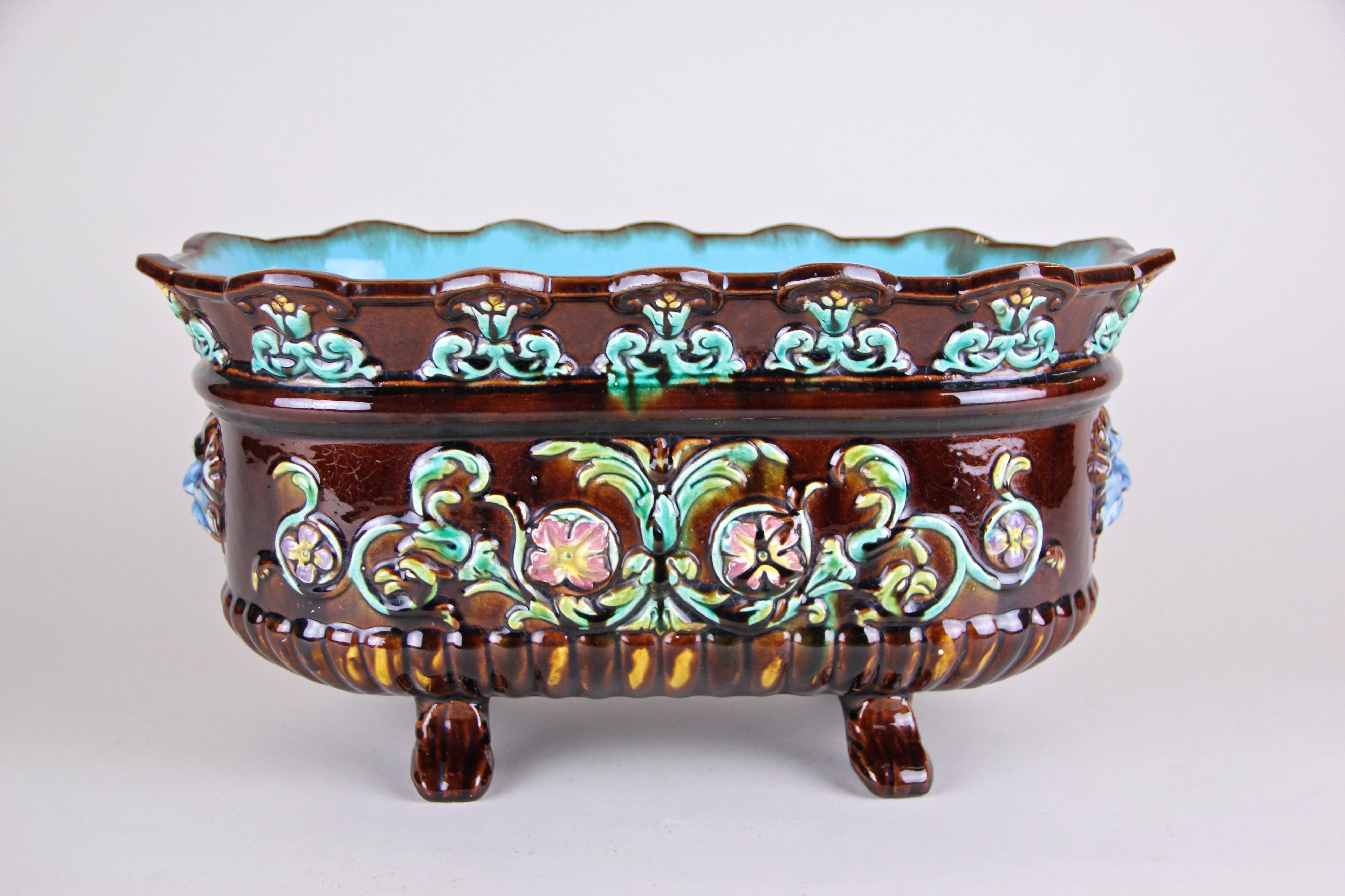 Exceptional colorful Majolica jardinière or cachepot from Art Nouveau period around 1915 in France. An unusual shape, delicate floral design elements and a beautiful coloration in brown, green, red and blue tones combined makes this piece of french