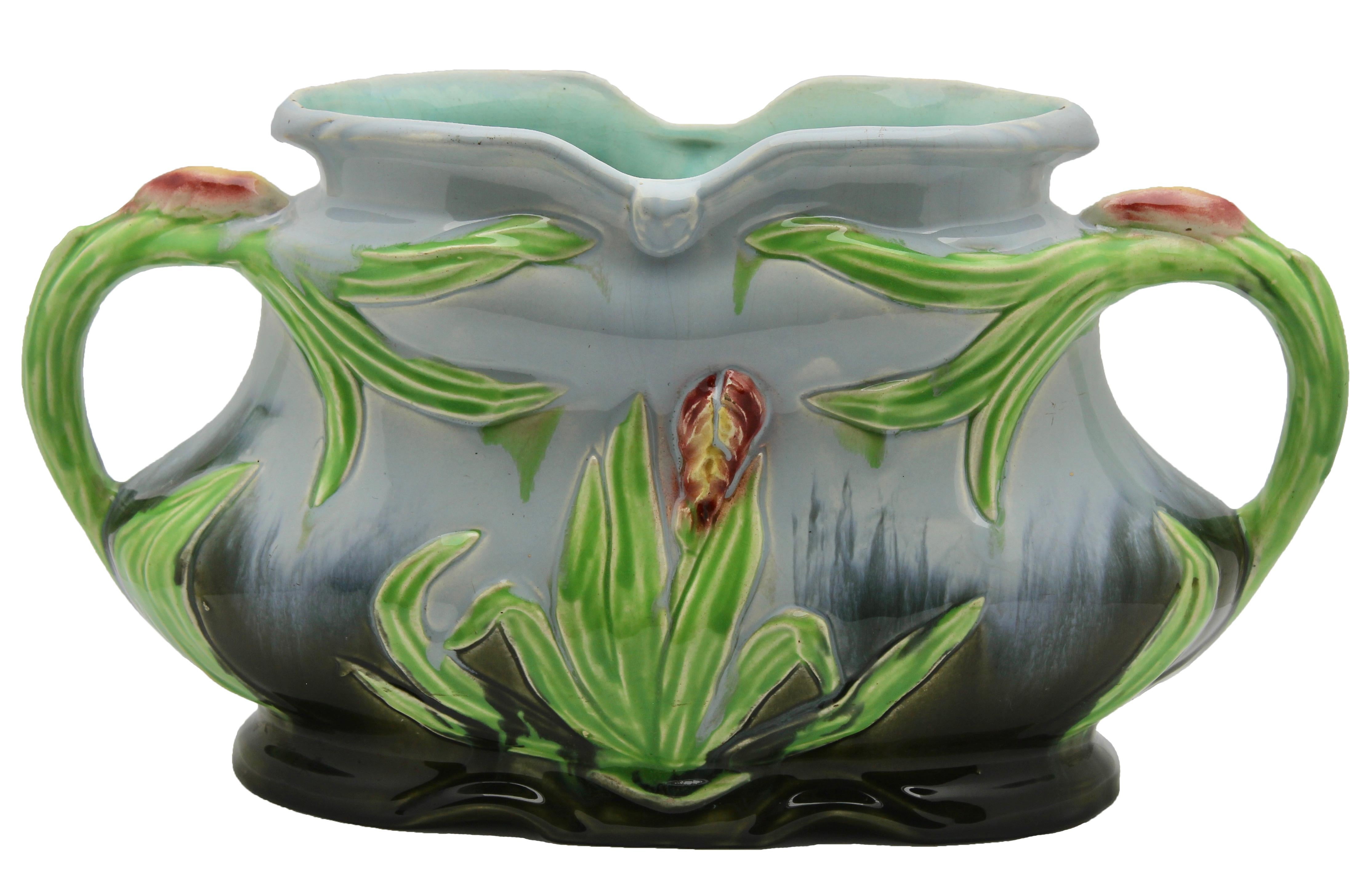 Majolica planter in barbotine technique with high relief, hand painted with flag-iris decoration
A colorful and Classic example for the side table or mantlepiece, comprises three pieces; two.
Similar upright vases with a larger jardiniere (or