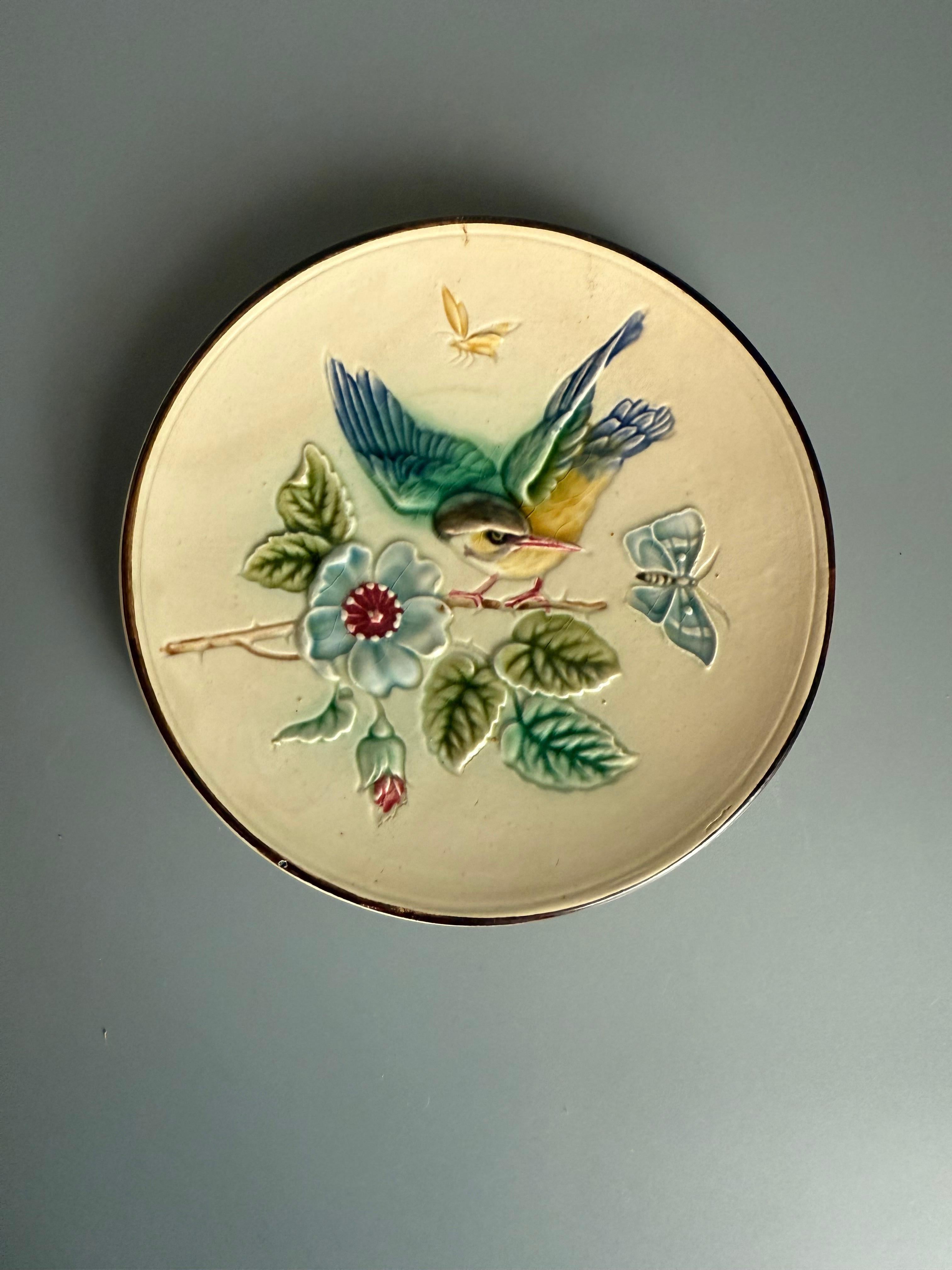 Art Nouveau Malolica Rörstrand Sweden 
This is a ceramic plate made with the Majolica technique, a type of tin-glazed earthenware
The plate features a relief-molded and hand-painted design of a bird perched on a flowering branch, often with