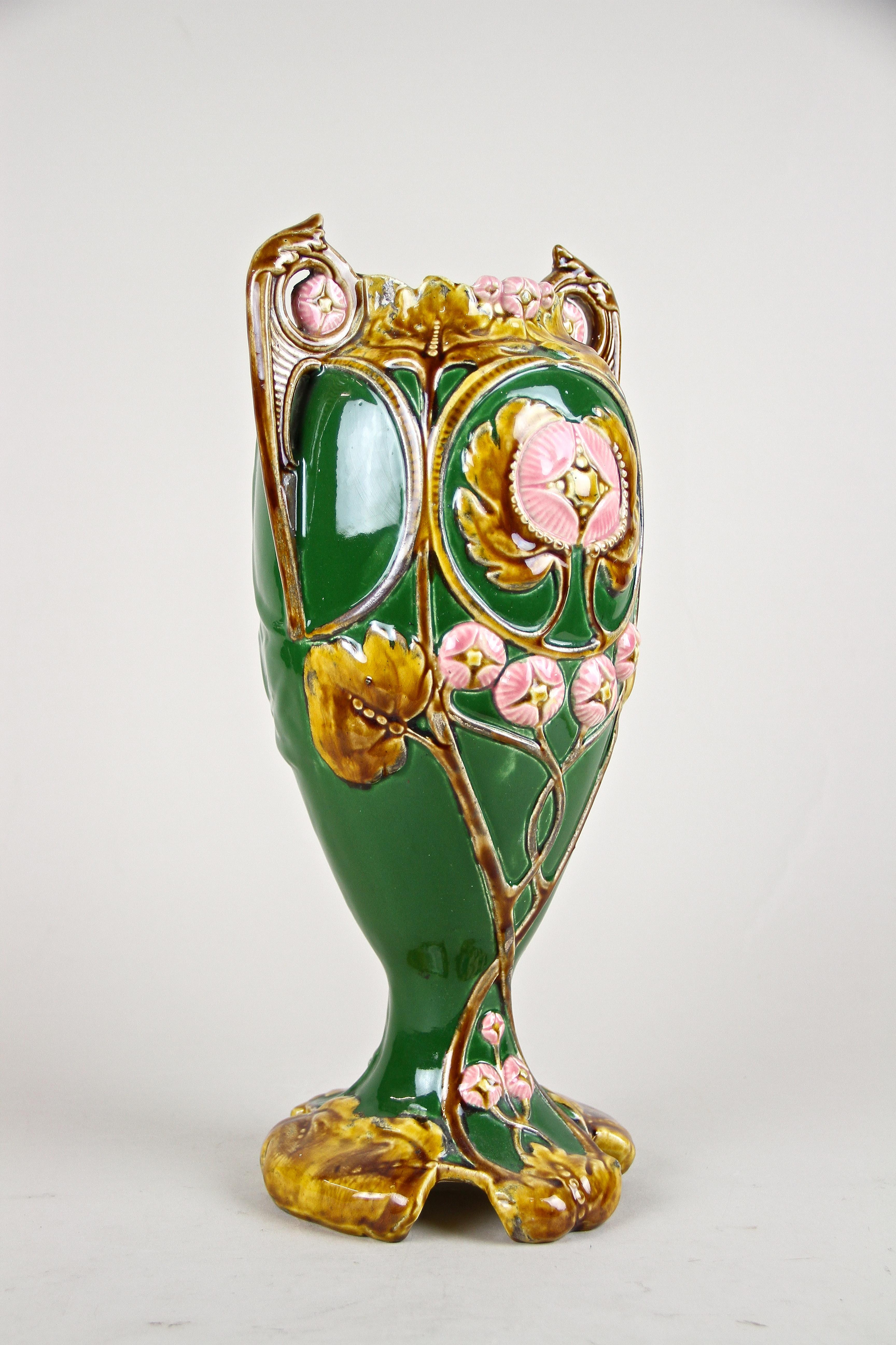 Beautiful Art Nouveau Majolica vase out of France from the early period around 1900 in great untouched, original condition. The unique designed dark green body impresses with an organic shape adorned by a floral theme, showing a lovely coloration in