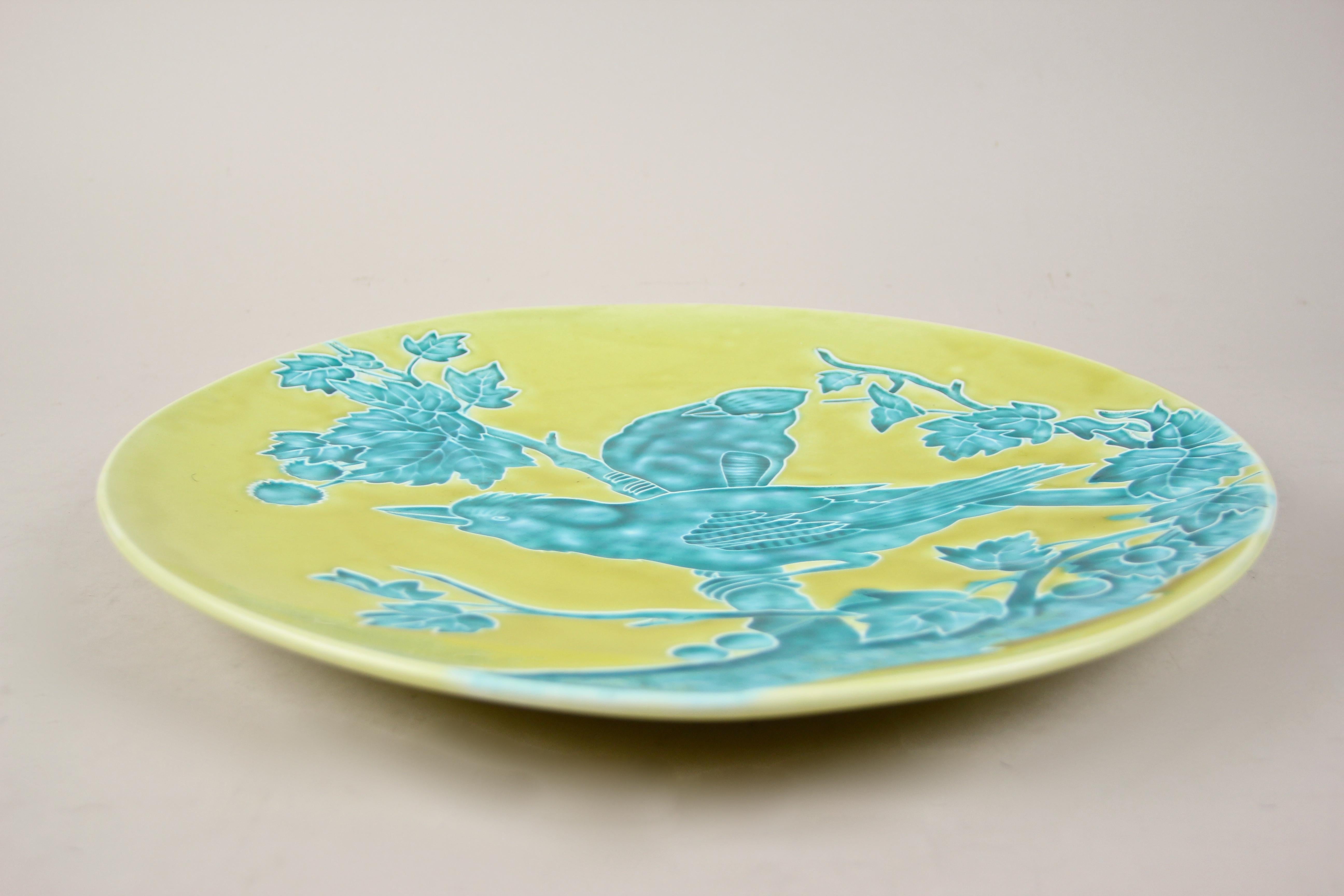 Exceptional Majolica wall plate from the famous company of Schuetz Cilli in Bohemia, circa 1910. This fancy large Majolica plate depicts two birds sitting on a tree branch with leaves. Colored in an amazing manner, a special turquoise tone, it