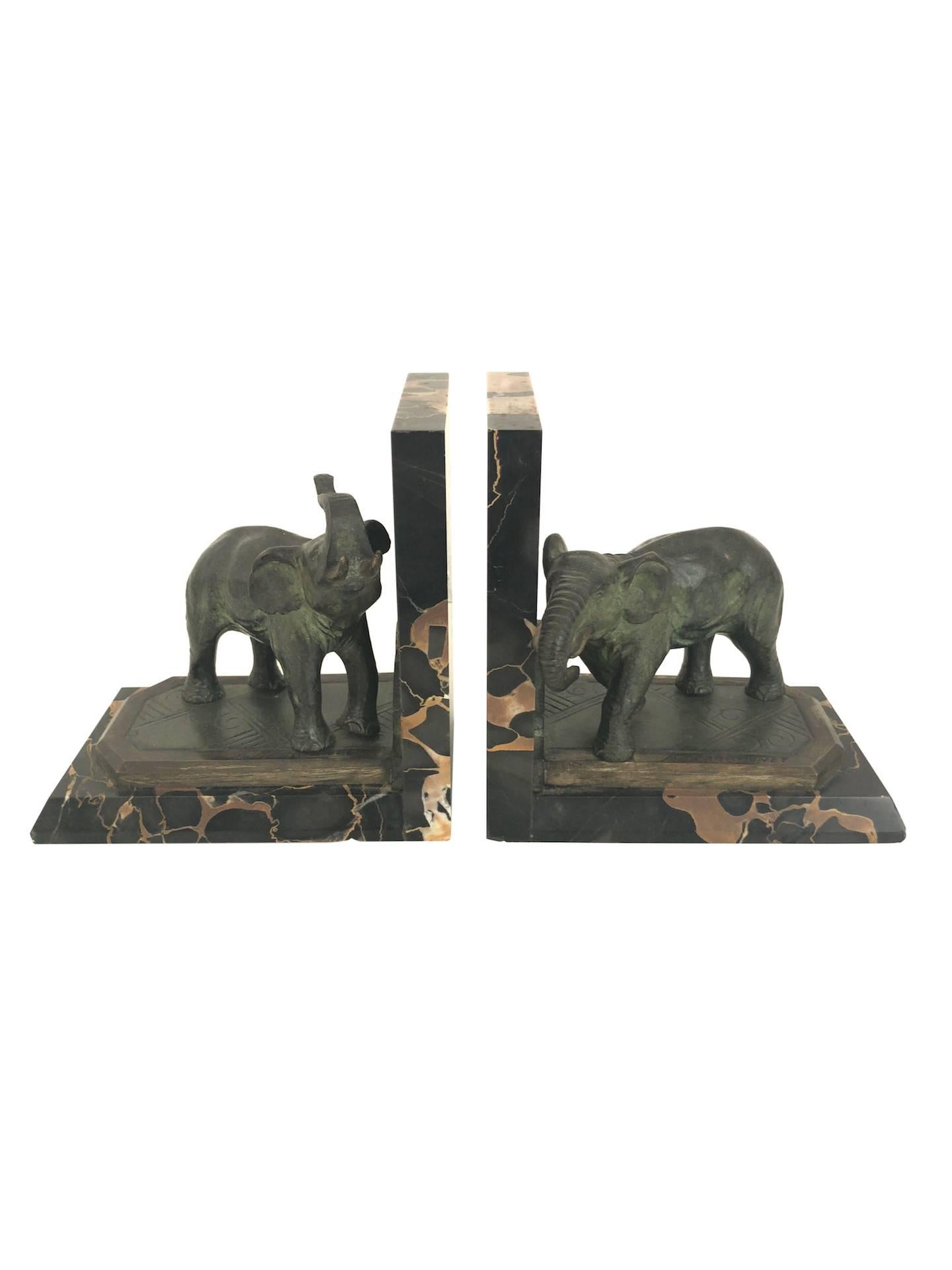 Bookends with elephants in two different poses
By Albert Marionnet (1852-1910), signed
France, circa 1900.

Material:
– Bronze, original patina
– Portor-marble socle 

Dimensions: 
Width 14.5 cm 
Height 14.5 cm 
Depth 9.5 cm.