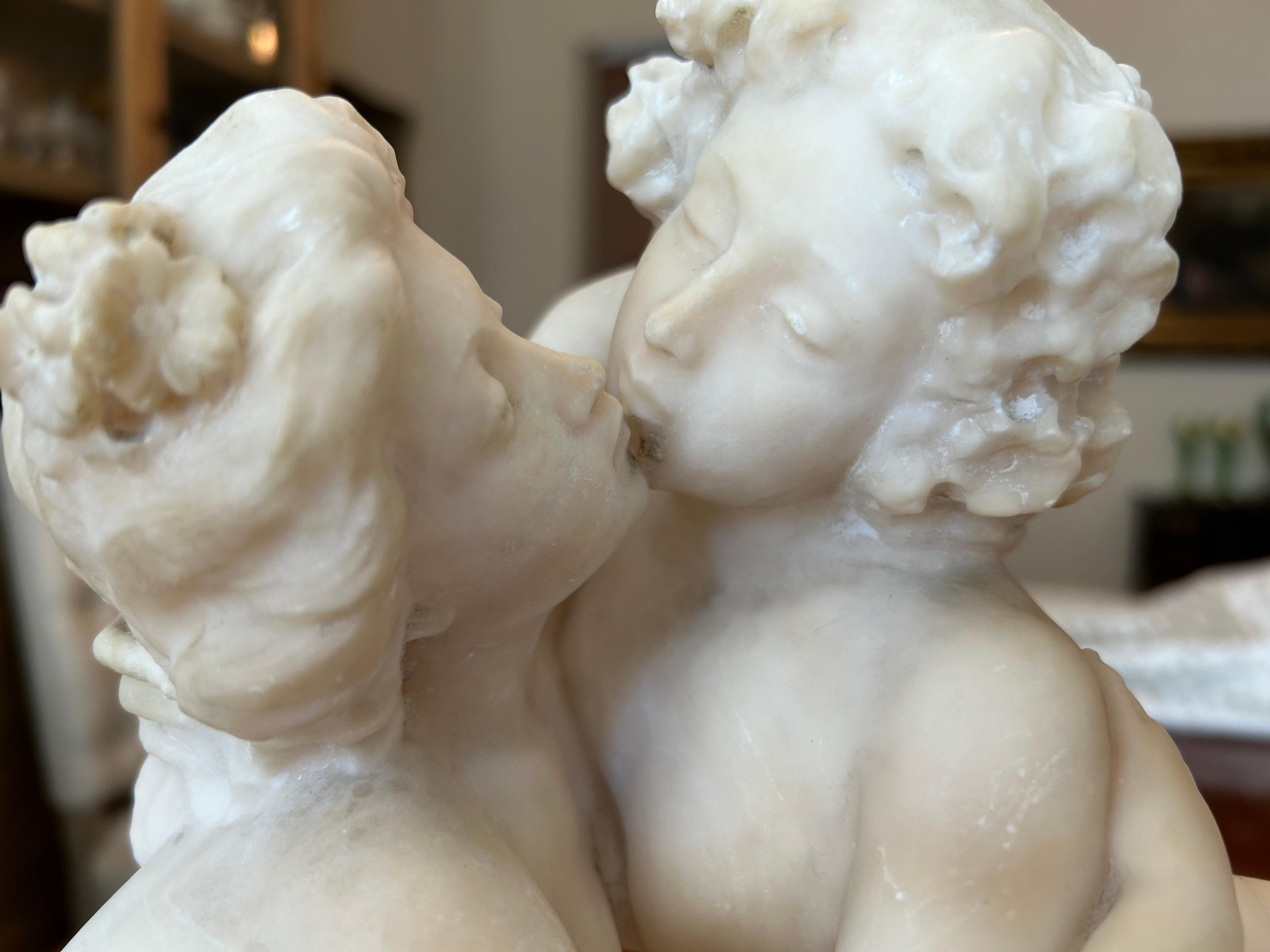 This is a stunning Art Nouveau marble sculpture, of two females kissing in front of a pool. Carved in marble, early twentieth century but possibly 19th, most probably French. The base inscribed with 