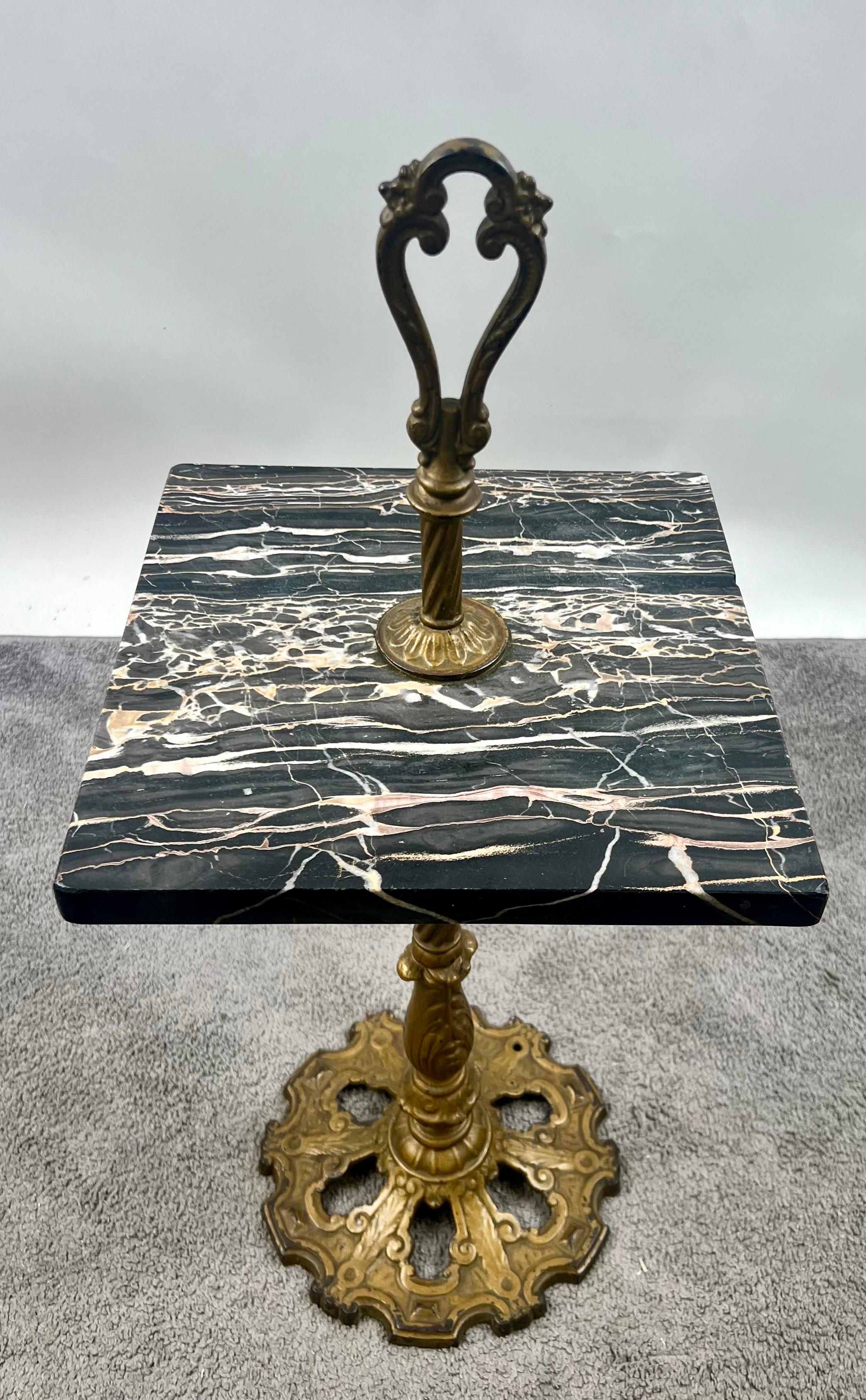 Art Nouveau Marble and Brass Smoking or Side Table: 
A refined Art Nouveau smoking table, featuring a richly veined square marble top in deep black with striking ribbons of cream and sienna. The surface rests on a decorative brass pedestal with a