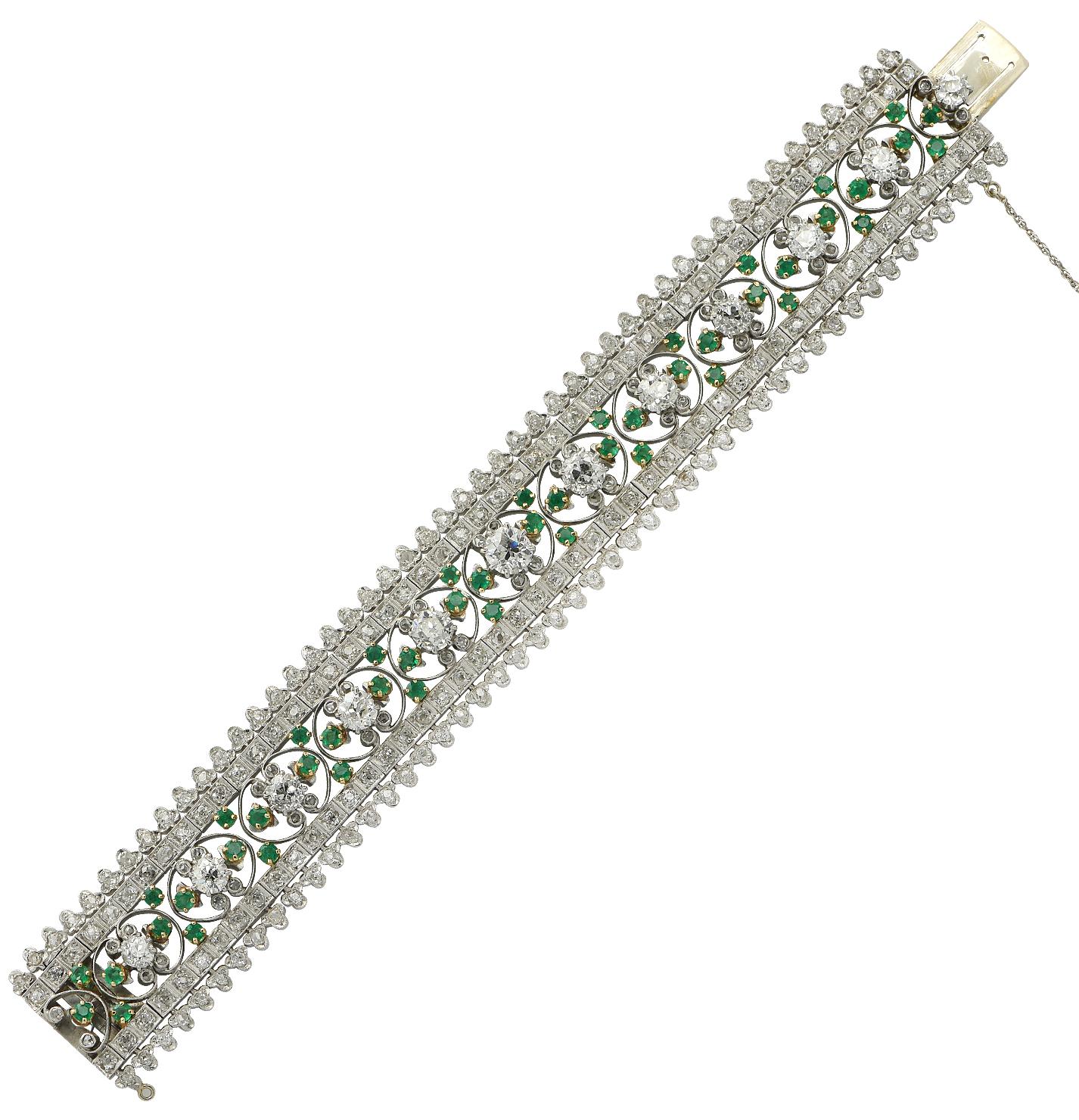Sensational Marcus & Co. Edwardian  bracelet crafted in platinum and 18 karat yellow gold. This spectacular bracelet features Old Mine Cut and Rose Cut diamonds weighing approximately 17.55 carats total, G-H color, SI clarity, and 48 round emeralds