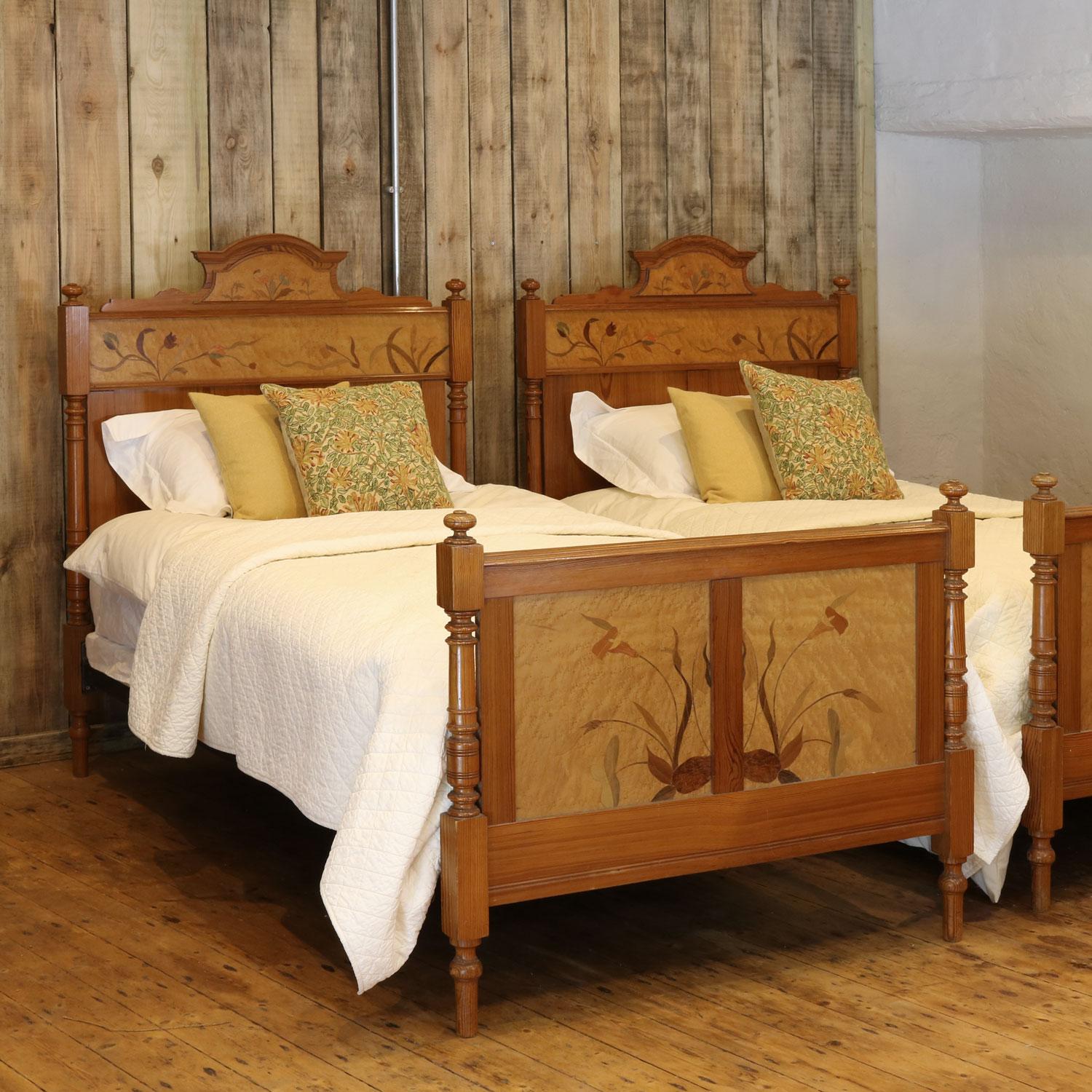 This elegant pair of pitch pine beds have fruitwood inlay and stunning floral designs on the head and foot boards. 

The price is for the beds and two standard firm bed bases. The mattresses and bedding are extra and can be provided.

The pair