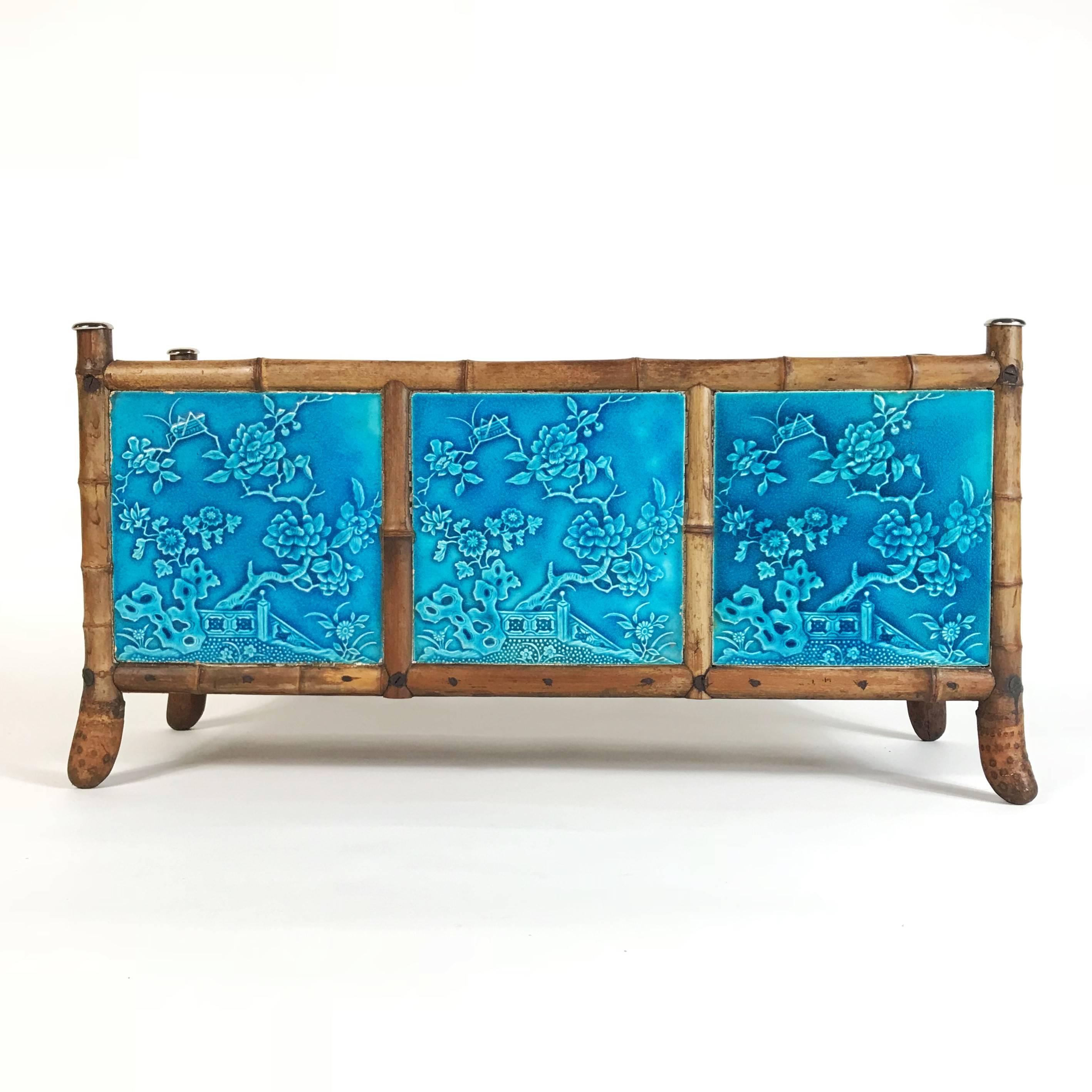 Unique Art Nouveau bamboo jardinière with three relief tiles incorporating japonais motifs by the manufacture Maw & Co. Benthall Works. The uniqueness of this planter is based on the feet made from bamboo roots. I found this rare object at an