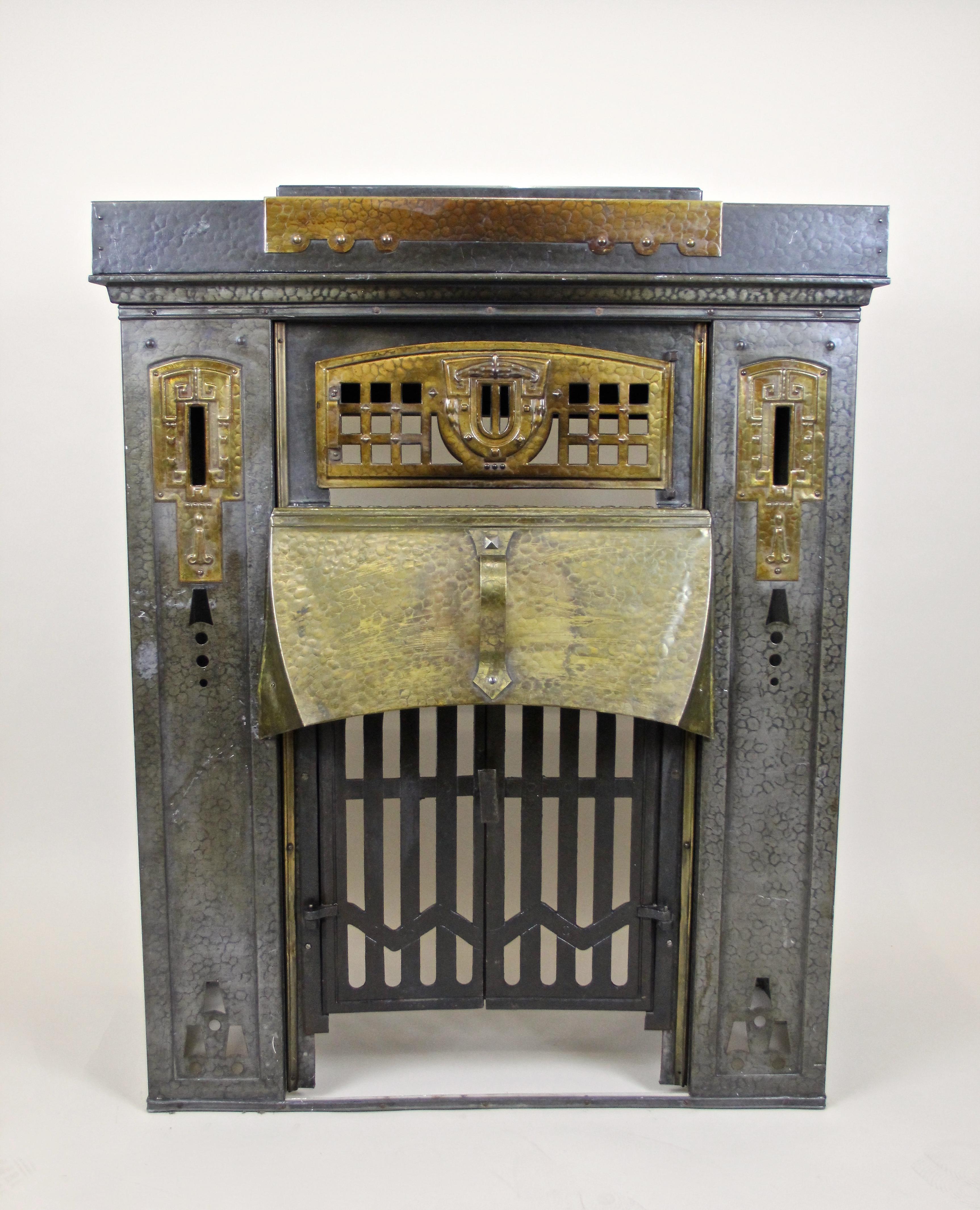 One of a kind early 20th century metal fireplace from the Art Nouveau period in Austria, circa 1900. This absolute unique fireplace was elaborately handcrafted and shows a beautiful hammered surface with fantastic cut Art Nouveau pattern on the