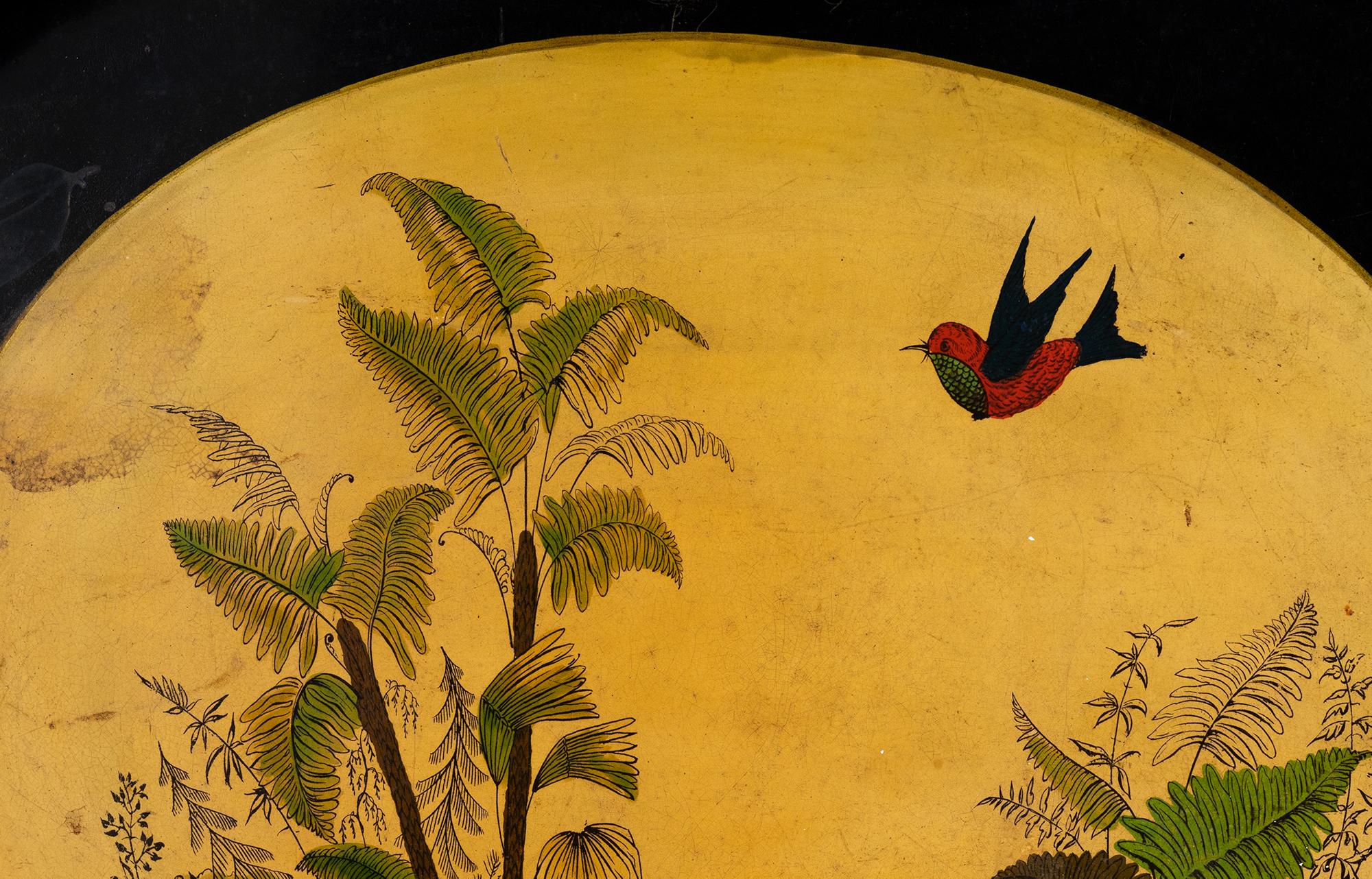 An oval metal tray with an acid painted oriental inspired scene of a ship at sea and a flying bird.
