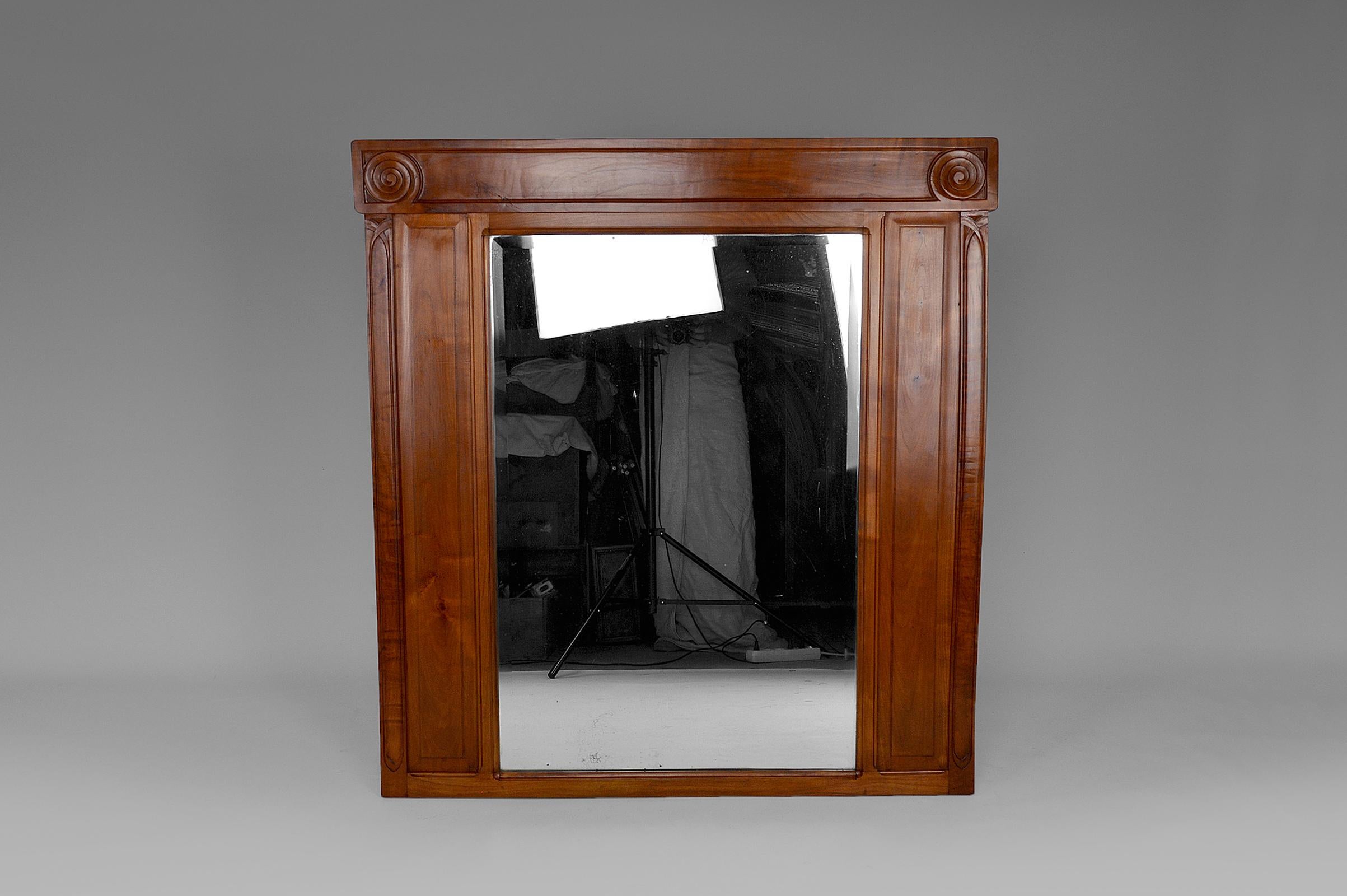 Overmantel mirror in carved cherry wood and beveled mirror.

Art Nouveau, France, circa 1910.
By the Toulouse cabinetmaker Maurice Alet, creator of the La Ruche Workshop.

In excellent condition, restored frame: stripping, treatment against