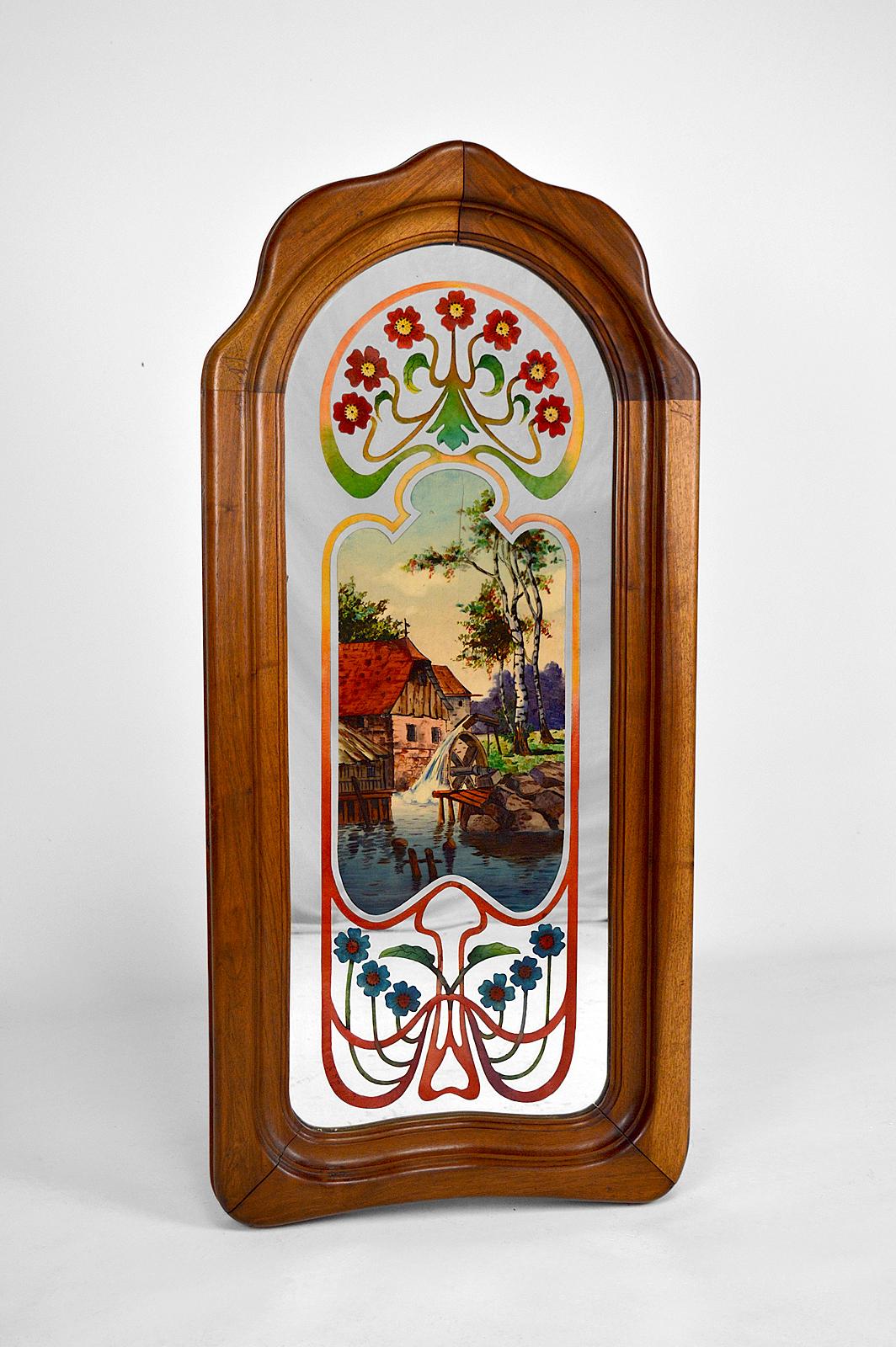 Beautiful Art Nouveau mirror with molded walnut frame.
The mirror is painted under glass with floral motifs and a bucolic scene: a watermill in the countryside.

Art Nouveau / Ecole de Nancy (School of Nancy), France, circa 1900.

Good