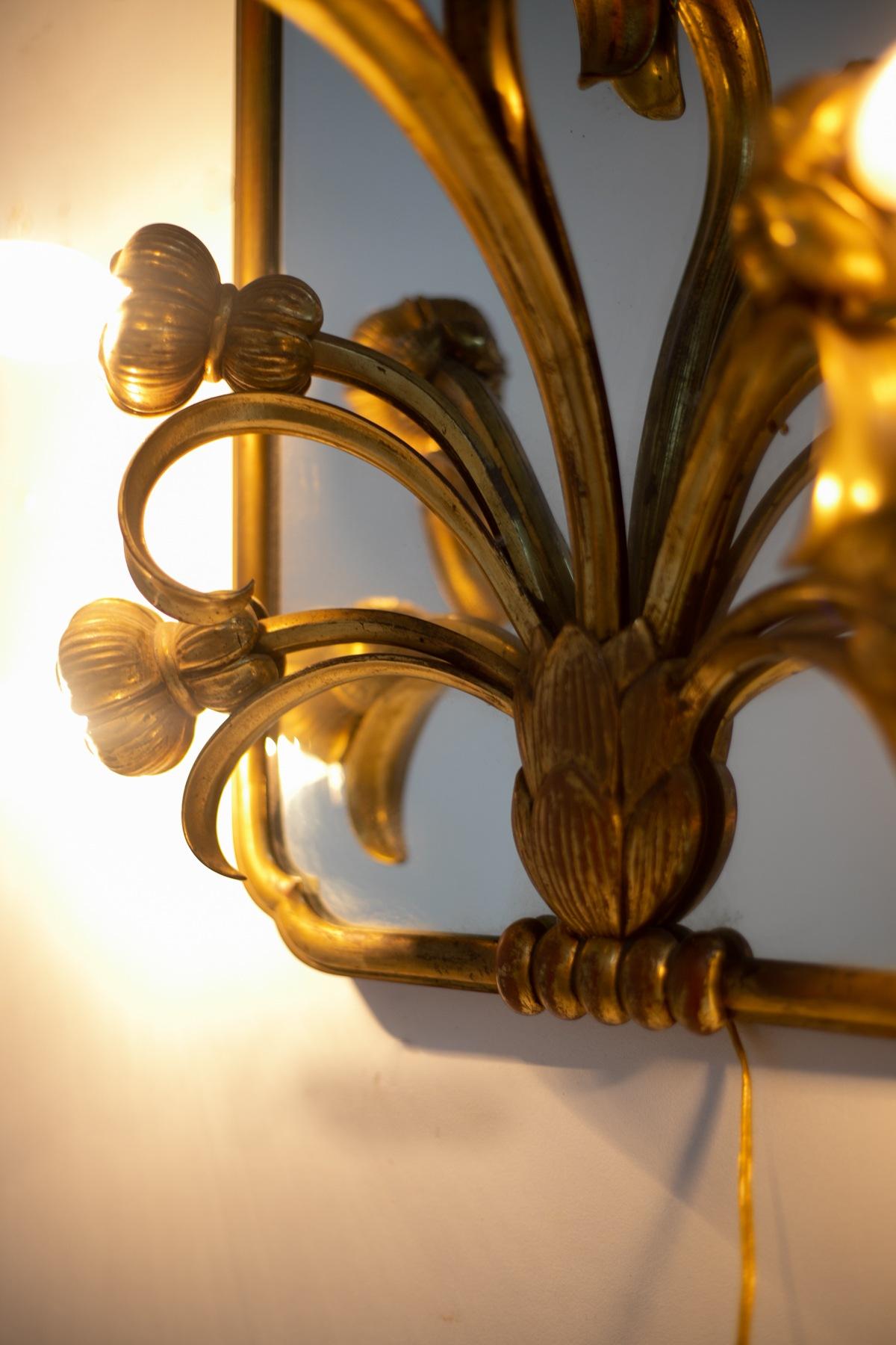 Wonderful mirror with applique from the Art Nouveau period, marvellous French manufacture, from a very chic Parisian restaurant.
The mirror has a rectangular shape with rounded corners, entirely made of brass in original patina. The top is