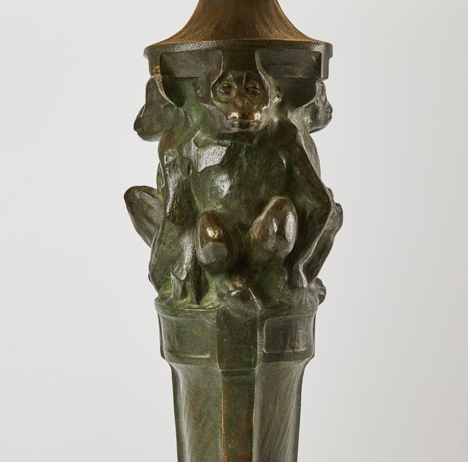 A fine decorative Art Nouveau green patinated bronze lamp with monkeys by Böhlmarks, Stockholm ca.1900. All wiring is new and done in old antique style. The lampshade is modern. 
Böhlmarks was founded in 1872 by Arvid Böhlmark and imported lamps in