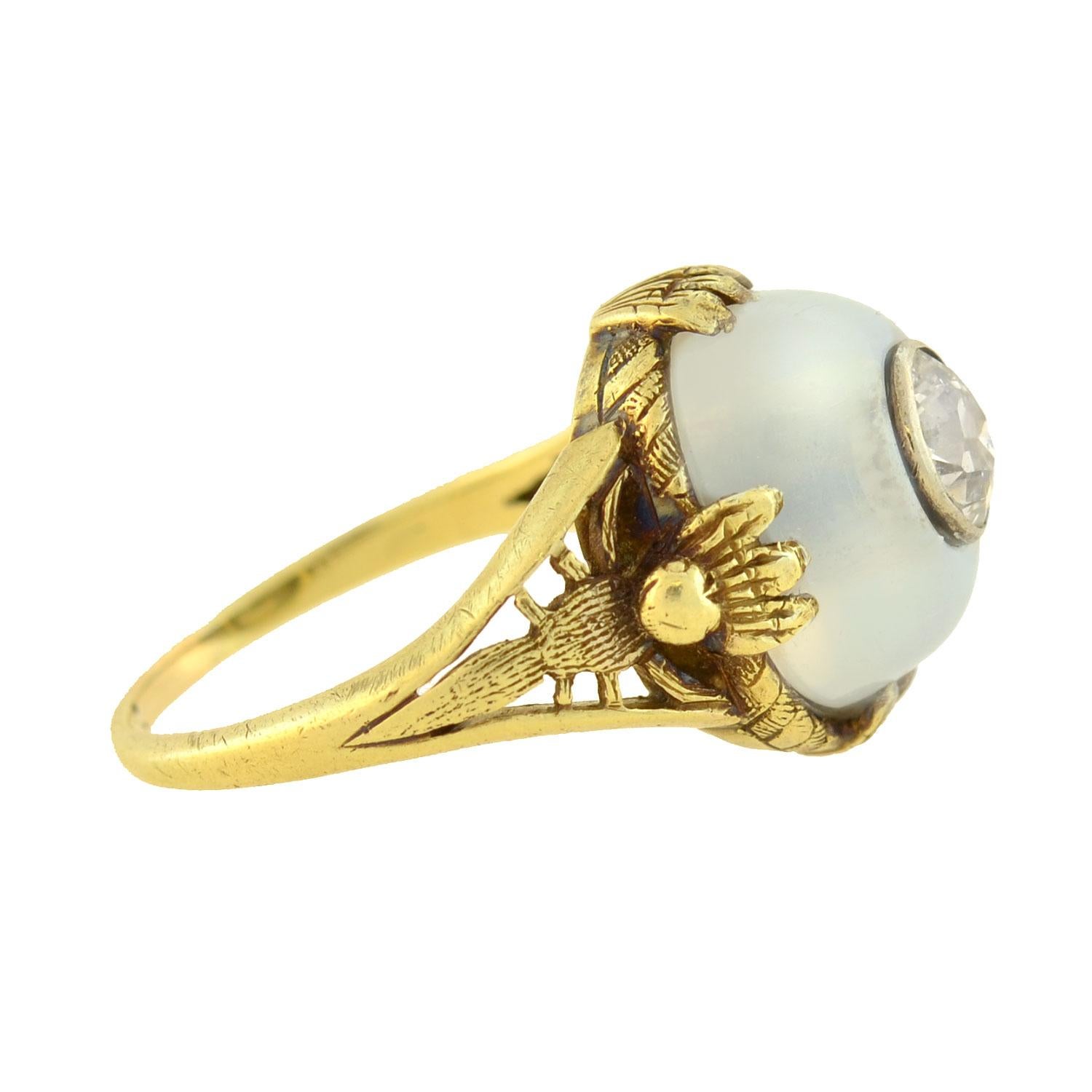 An incredible moonstone and diamond ring from the Art Nouveau (ca1900) era! Crafted in 14kt yellow gold, this fantastic and unusual piece has an artistic wirework setting which holds a large moonstone cabochon at its center. The oval shaped