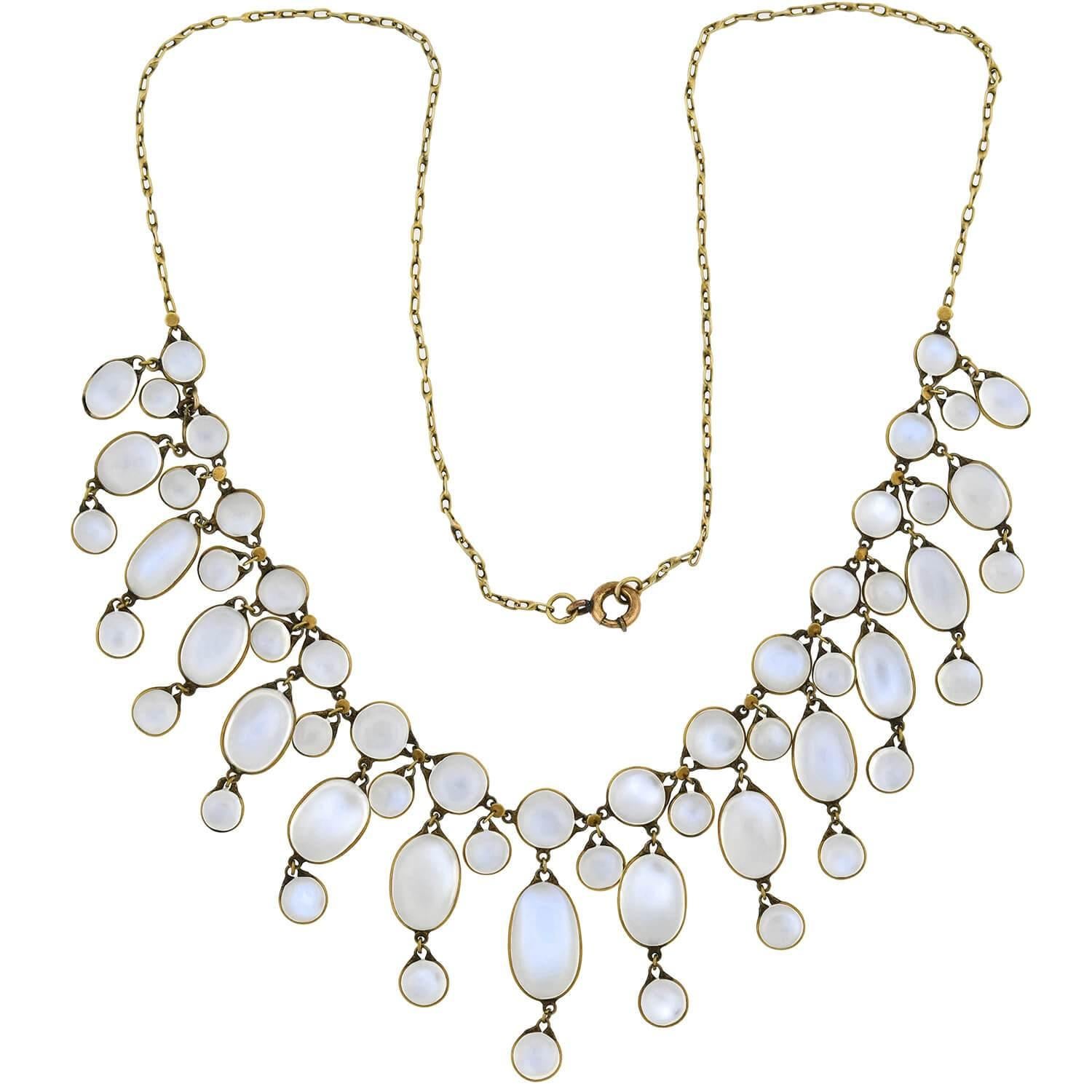 A stunning moonstone necklace from the Art Nouveau (ca1900s) era! This gorgeous piece is comprised of a multitude of moonstone links, which hang in a festoon style from a 14kt gold chain. Included in the design are a combination of round and oval