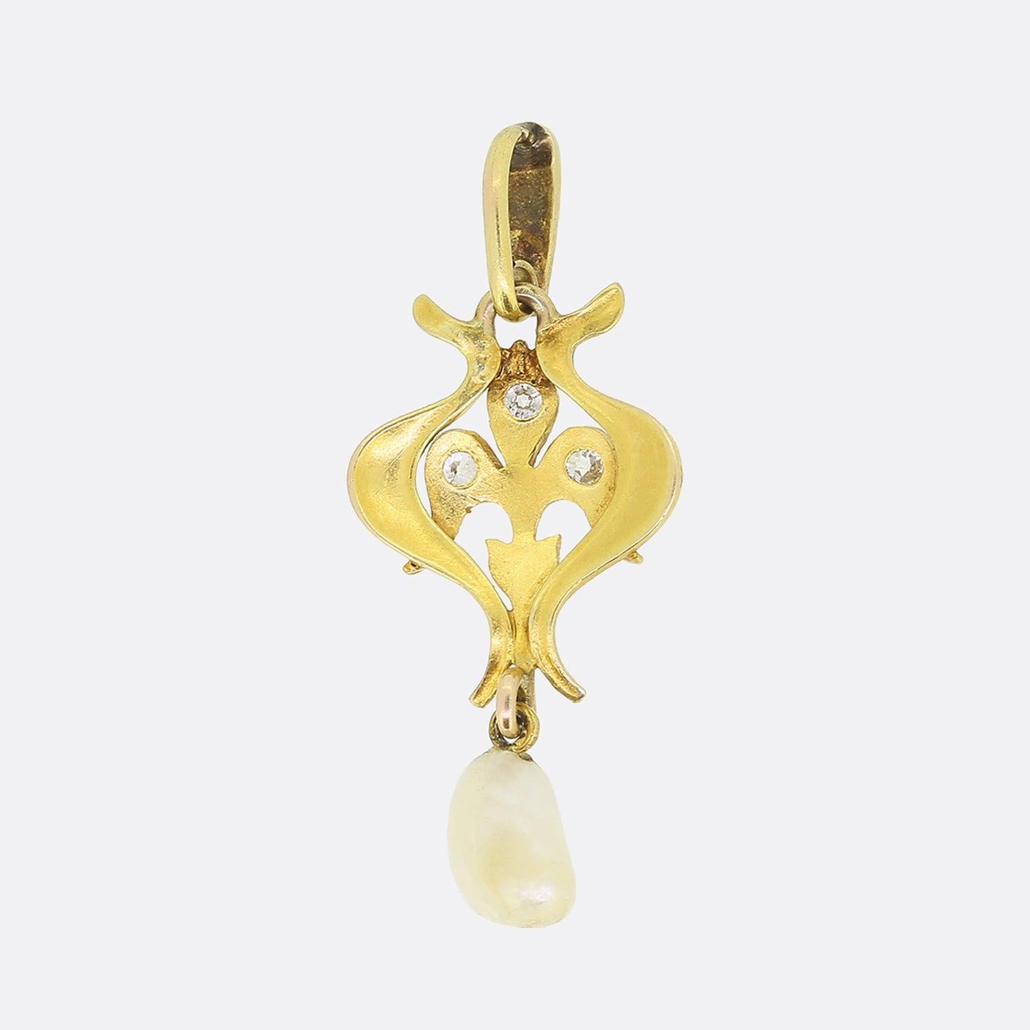 This is an Art Nouveau 15ct yellow gold natural pearl and diamond pendant. The highly decorated, iconic Art Nouveau frame has a floriated design, composed of sinuous leaves and a diamond set 'fleur de lis' in the centre. At the bottom of the pendant