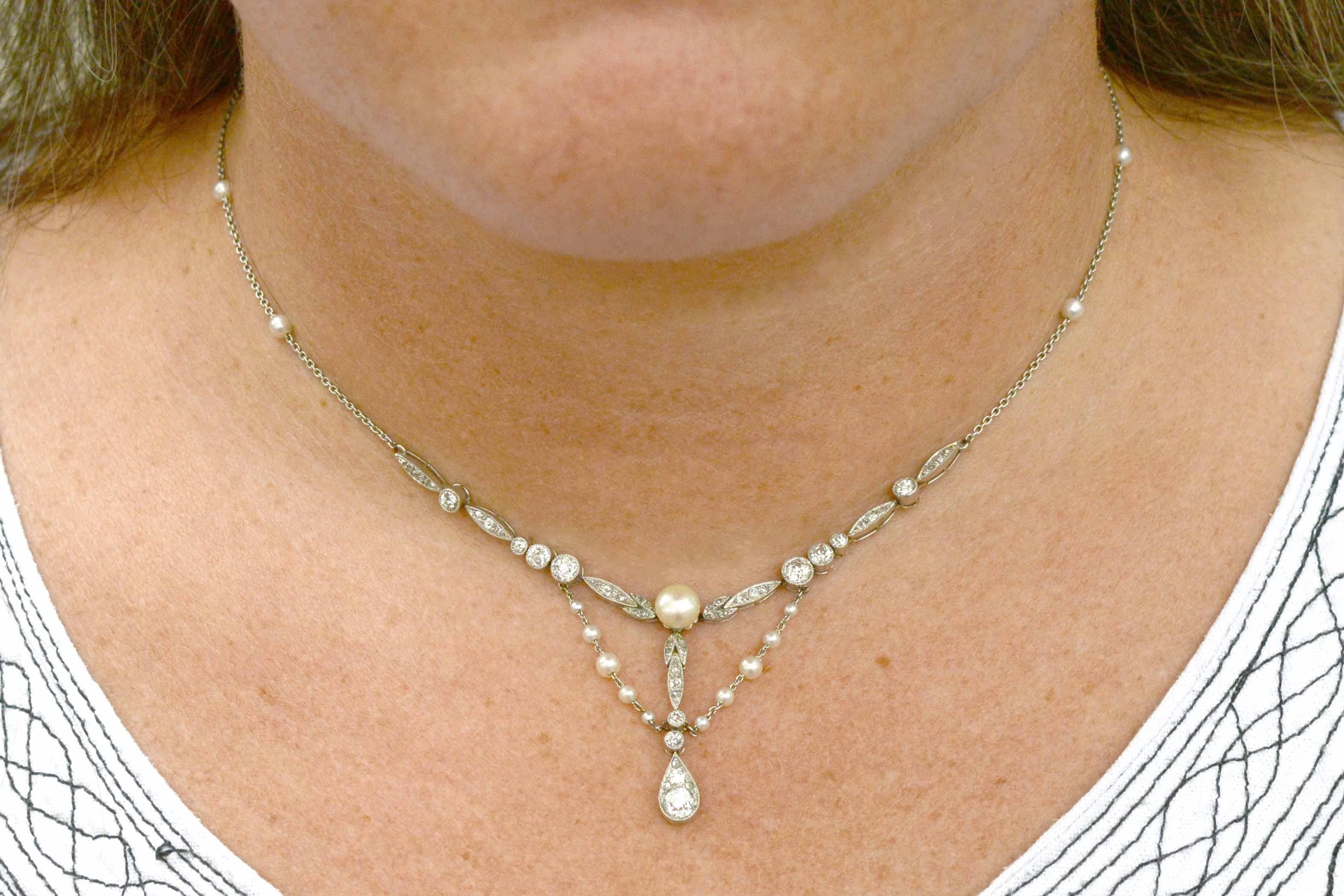 This necklace is on hold for a customer.

An intriguing, authentic and feminine Art Nouveau natural pearl and diamond negligee necklace. The bib style lavalier drapes wonderfully on the wearer and can pair with a simple blouse or evening gown. This