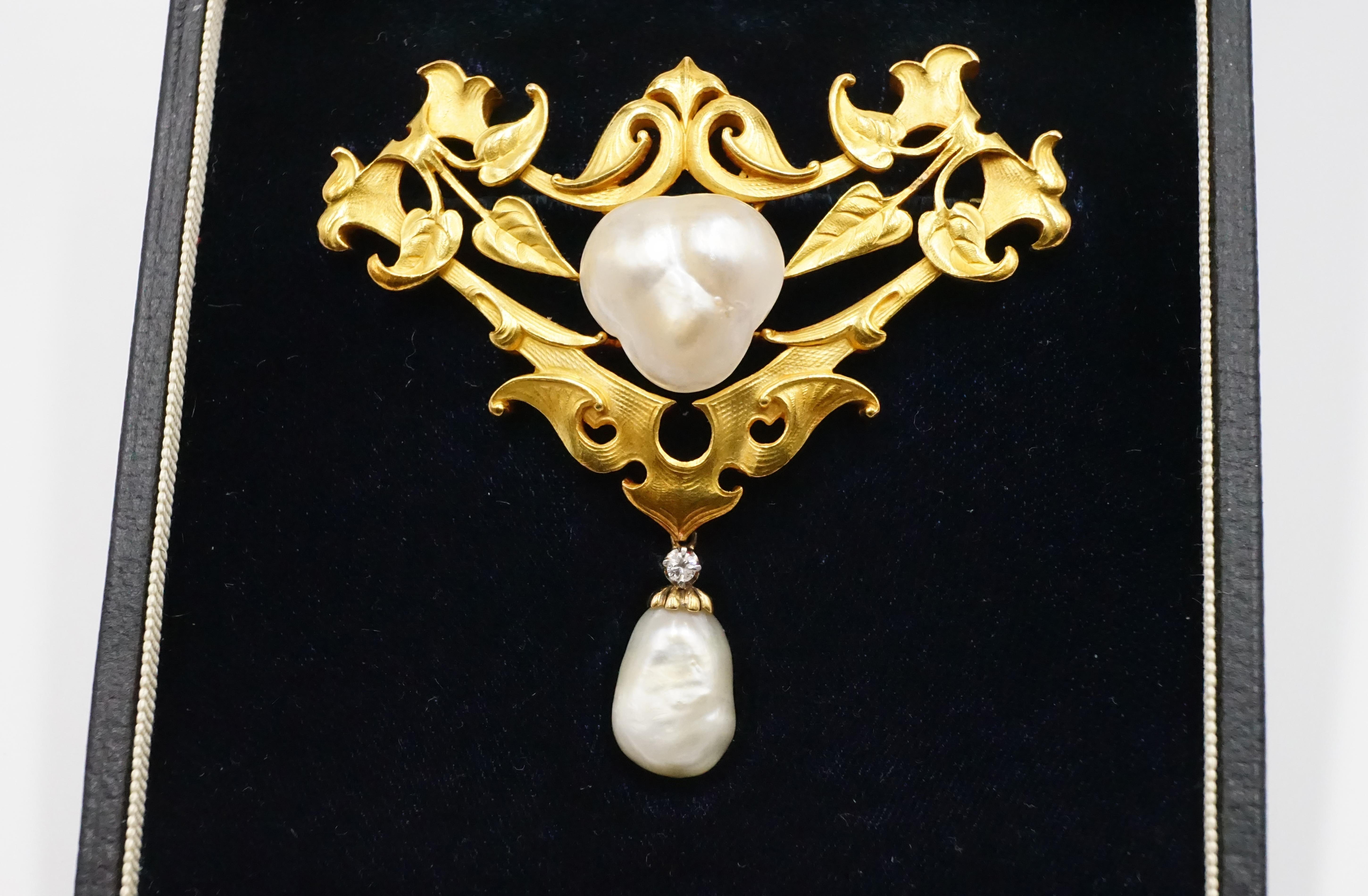 An elegant Art Nouveau natural pearl, gold and brilliant cut diamond brooch, both pearls are natural the heart-shaped pearl measures W:1.6cm H:1.55cm D: approx 0.7cm and the drop pearl measures W: 1.3cm H:1cm D: 0.7cm both certificates are