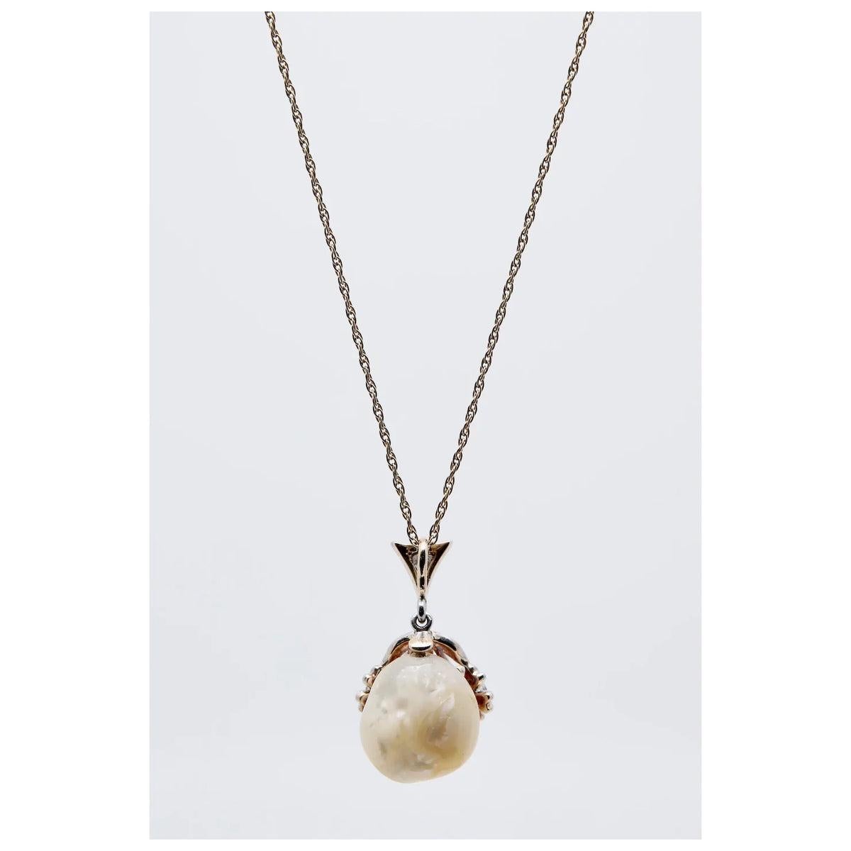 Aston Estate Jewelry Presents:

An Art Nouveau period diamond, and natural river pearl pendant in platinum. Featuring a natural freshwater American river pearl accented by two diamond set flowers and suspended from a diamond set bale. Weighing a