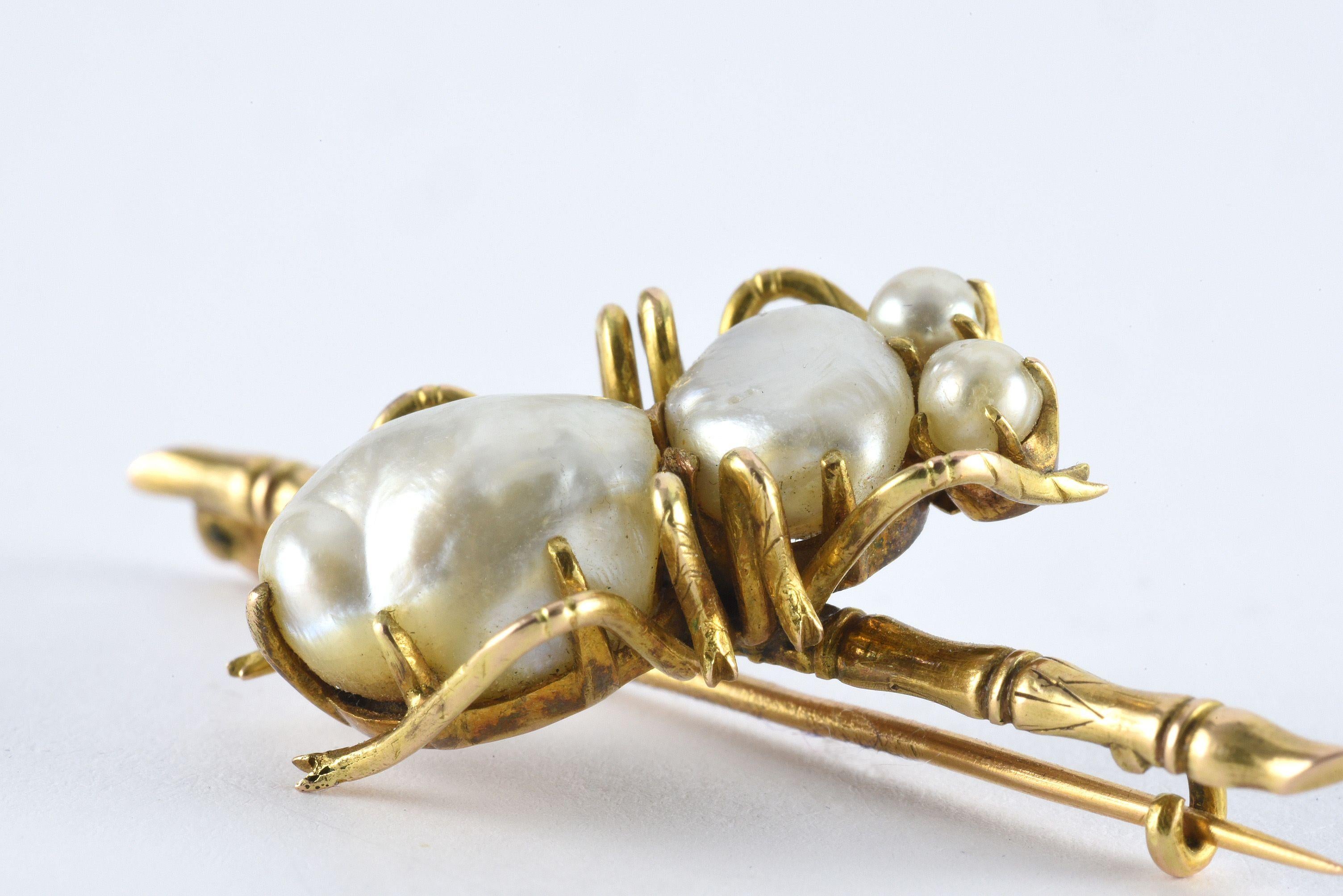 Four natural white pearls adorn this vintage Art Nouveau bug brooch fashioned from 18kt yellow gold. Circa 1890s. 
