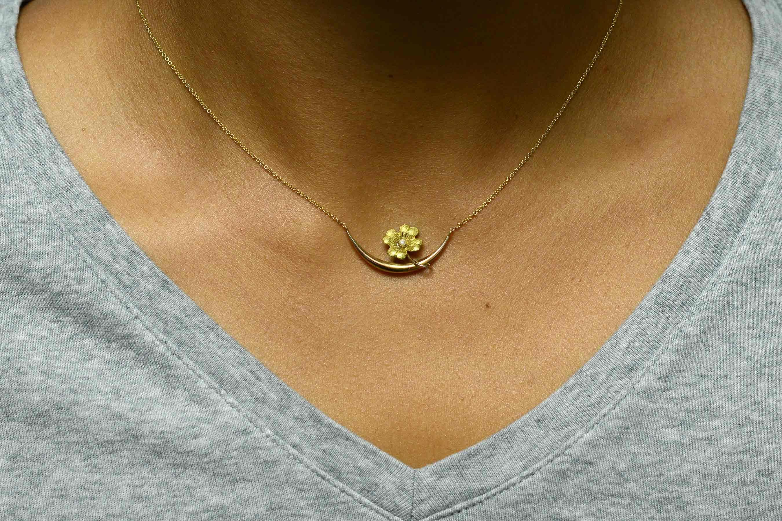 A simply lovely antique Art Nouveau necklace centered by a delightful forget-me-not flower with a lustrous, natural pearl center. Originally a pin that we converted into a necklace, giving this vintage floral brooch a new life. Eminently wearable