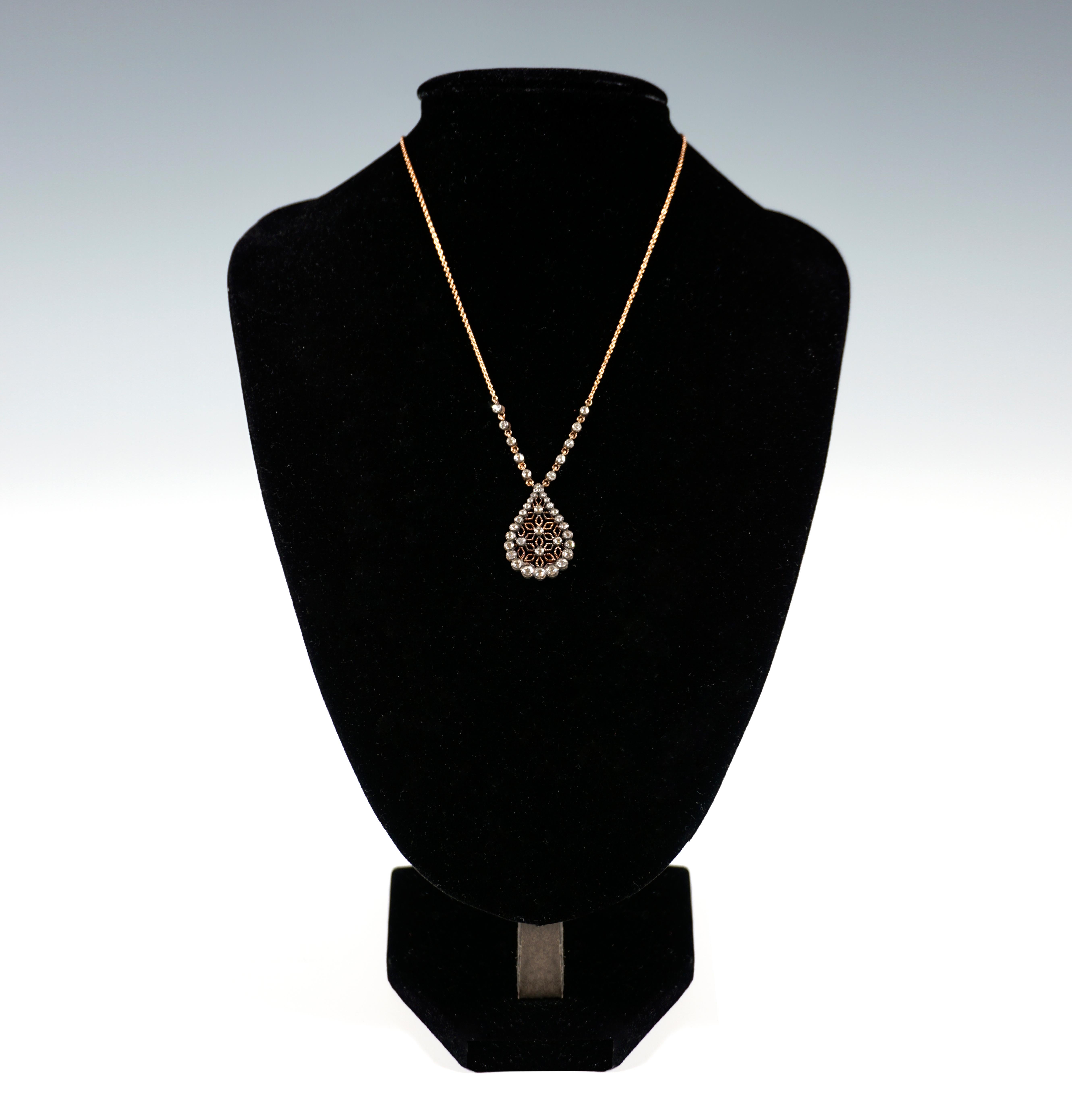 Delicate necklace with drop-shaped pendant, openwork with star-shaped branching, chased on the surface, attached rose-cut diamonds in various sizes frame the pendant, individual diamonds form centers in the cut-out stars, 5 diamonds at the base of