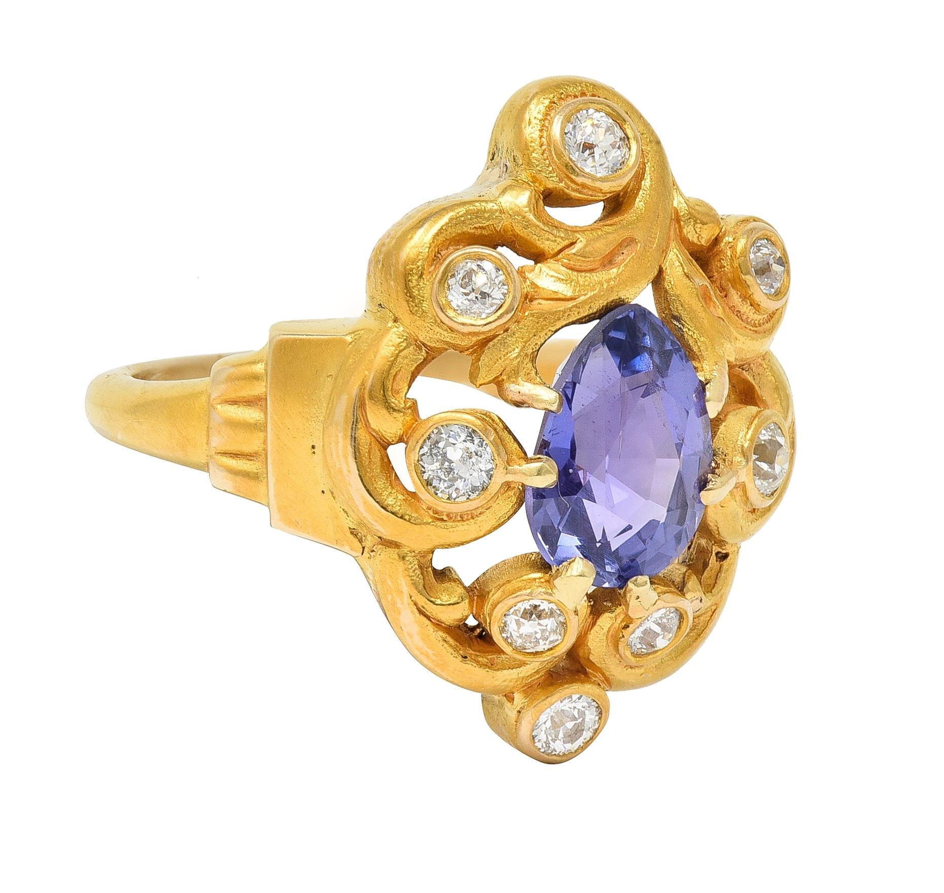 Centering a pear-cut sapphire weighing approximately 2.05 carats - transparent medium violet in color
Natural Ceylon in origin with no indications of heat treatment - prong set 
With a pierced openwork scroll motif surround bezel set with